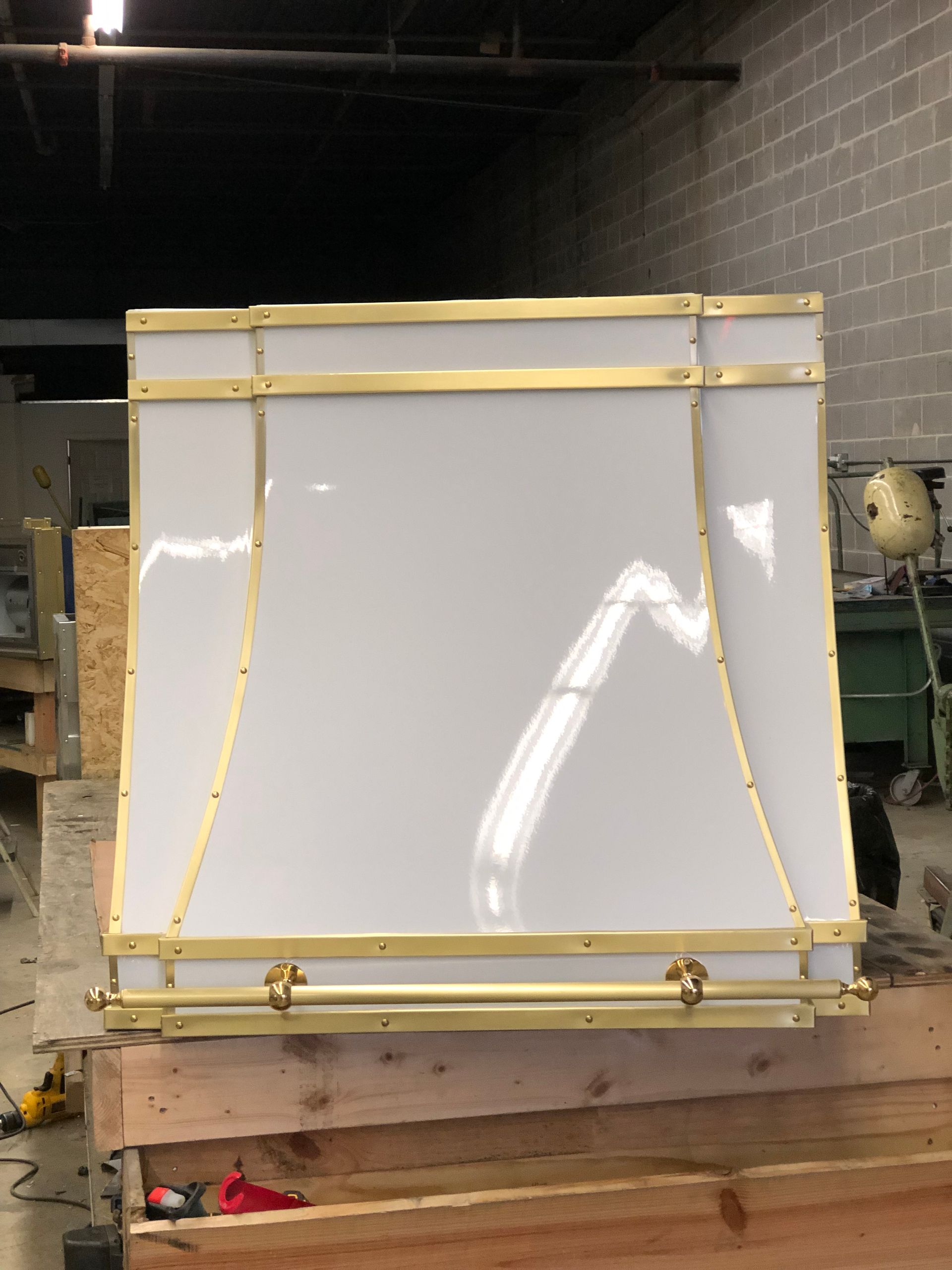 A white board with gold trim is sitting on a wooden pallet