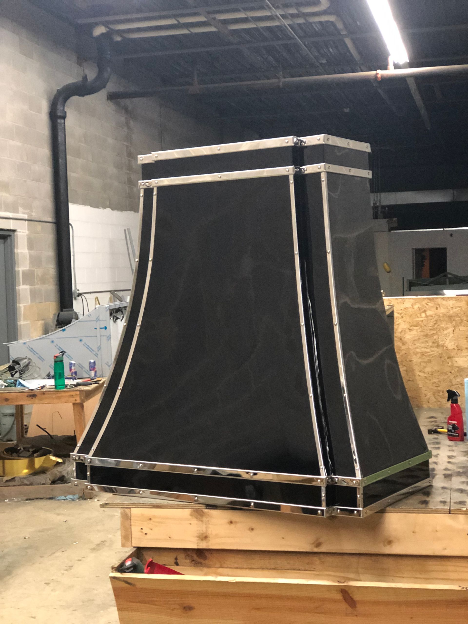 A black hood is sitting on top of a wooden box