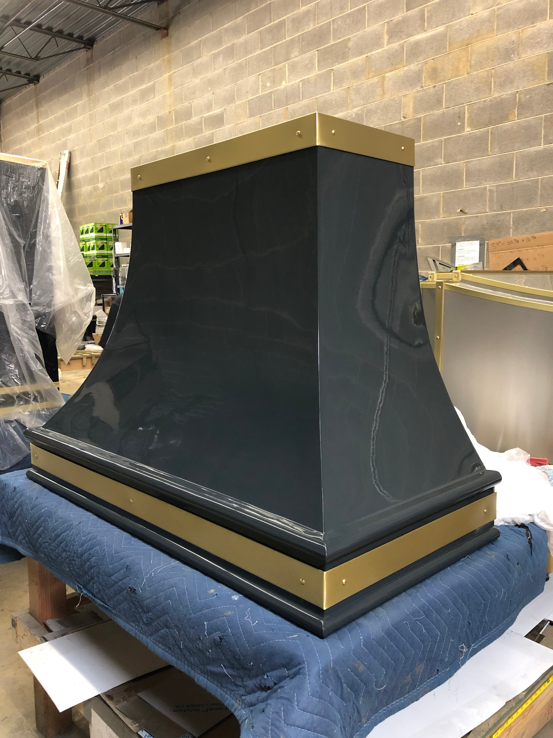 A black and gold hood is sitting on top of a table.