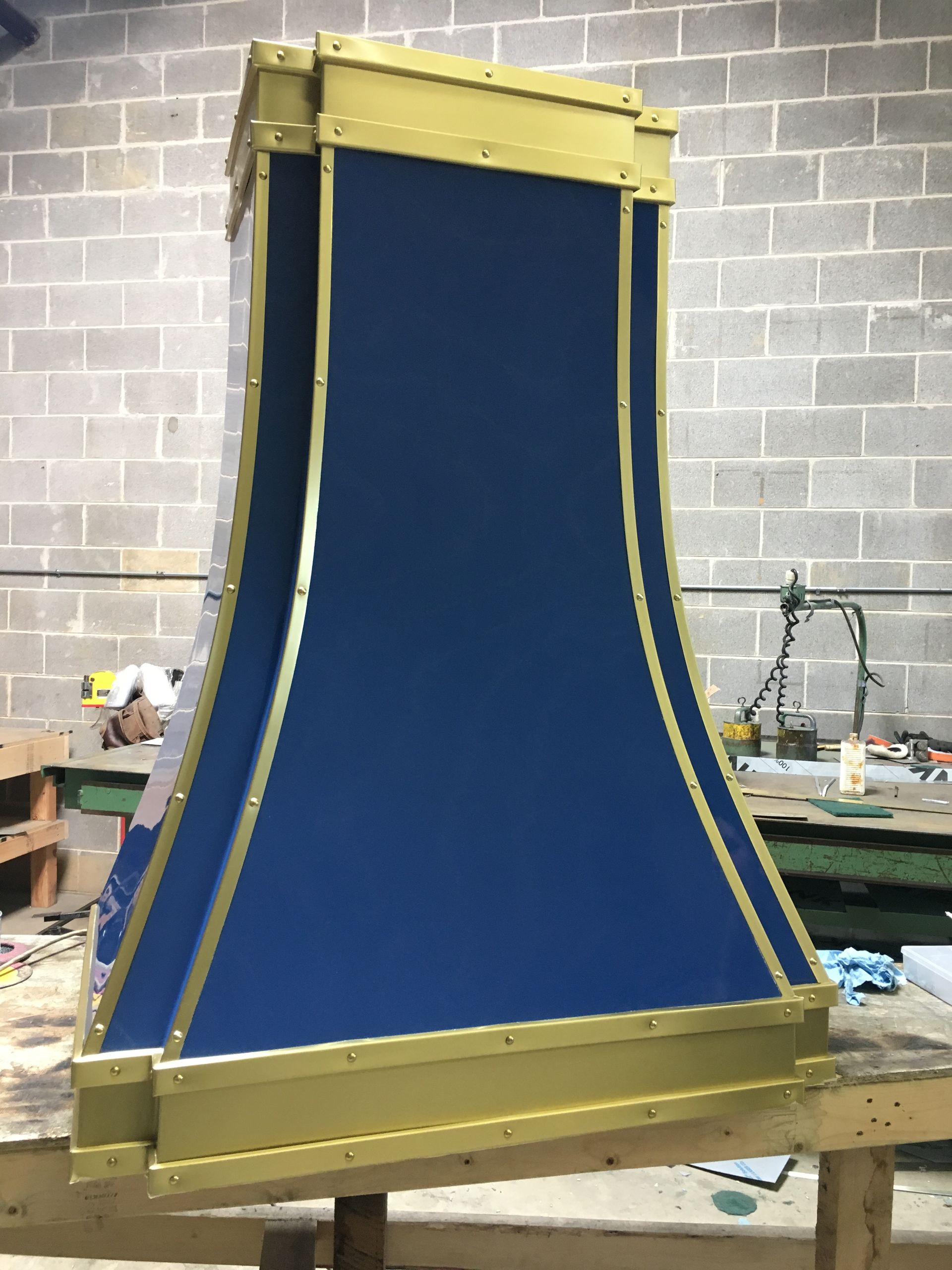 A blue and gold item is sitting on a wooden table