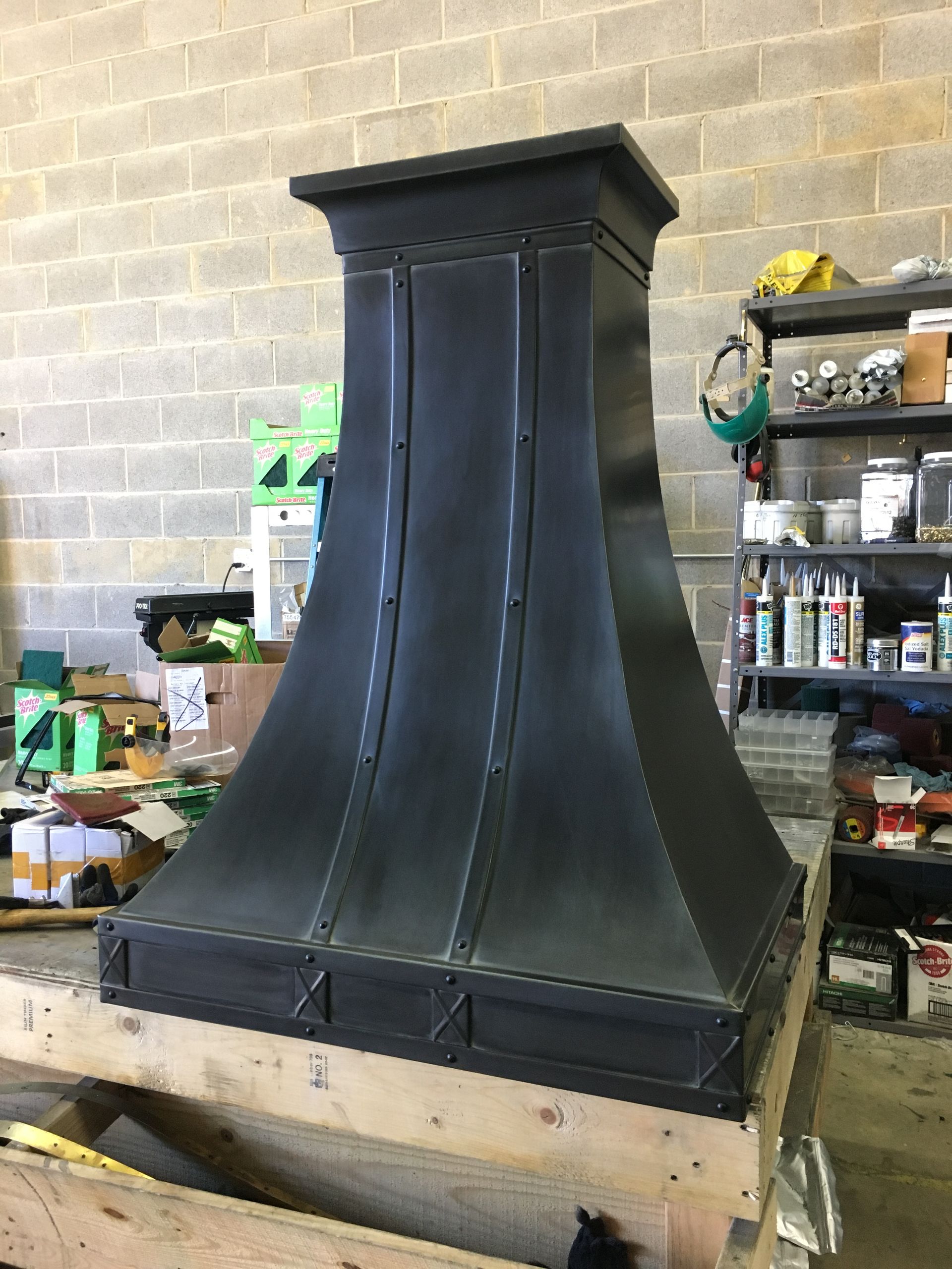 A black chimney is sitting on top of a wooden table in a room.
