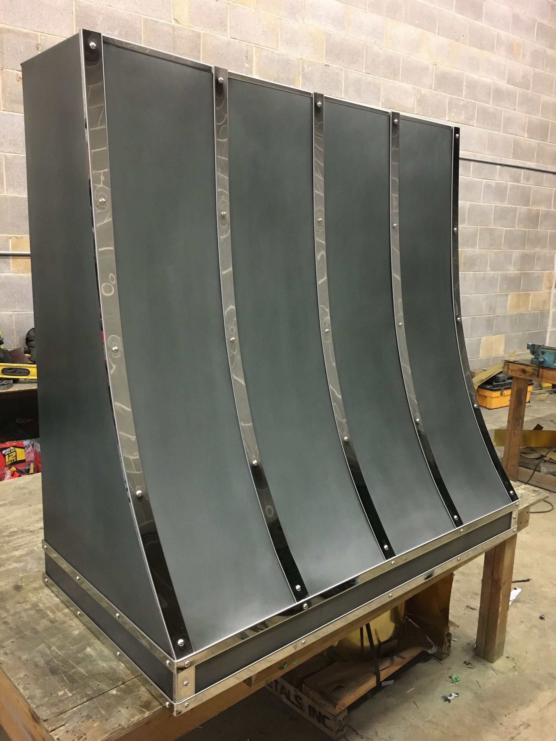 A black metal item is sitting on top of a wooden table.