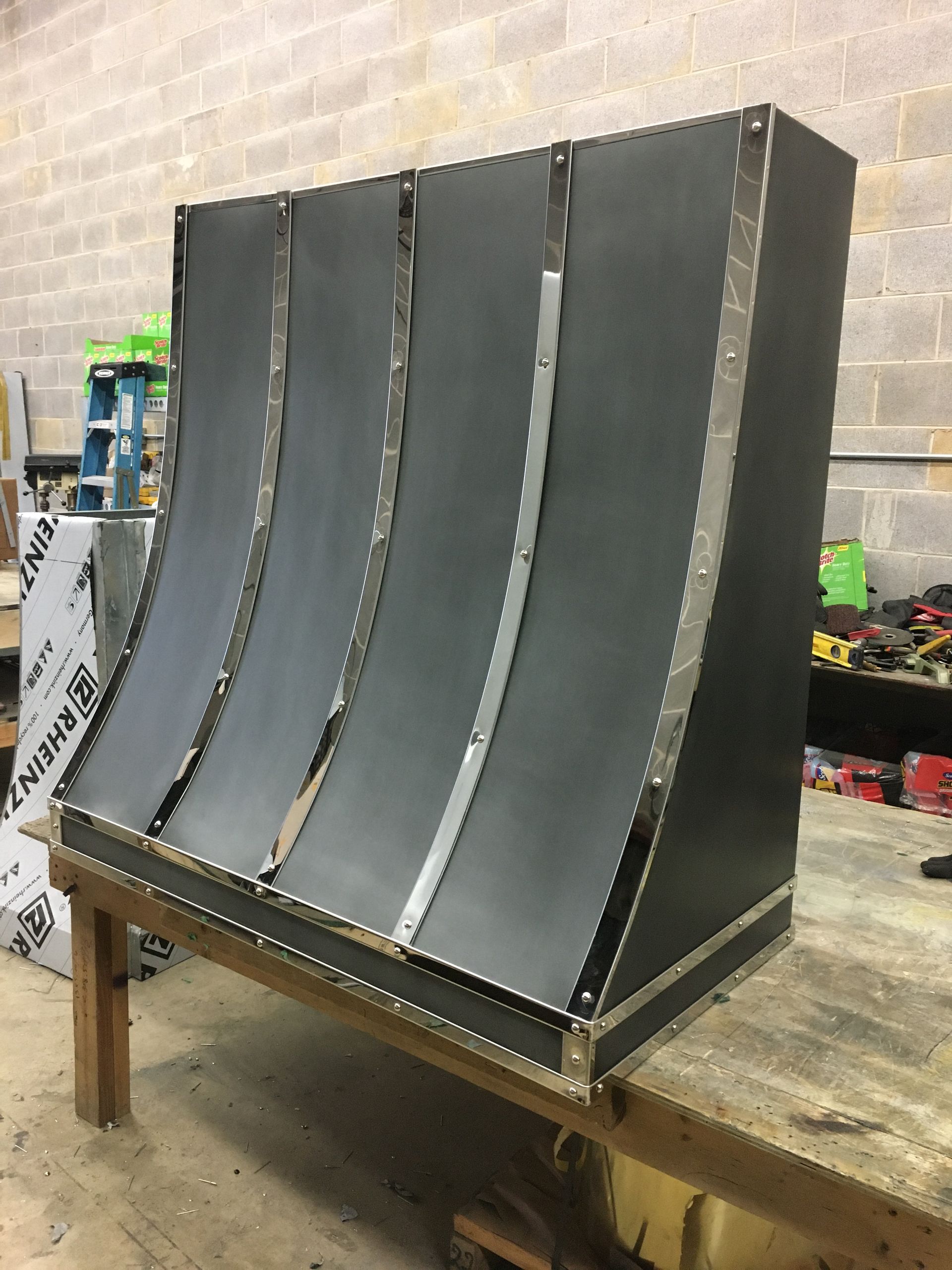 A piece of metal is sitting on top of a wooden table.