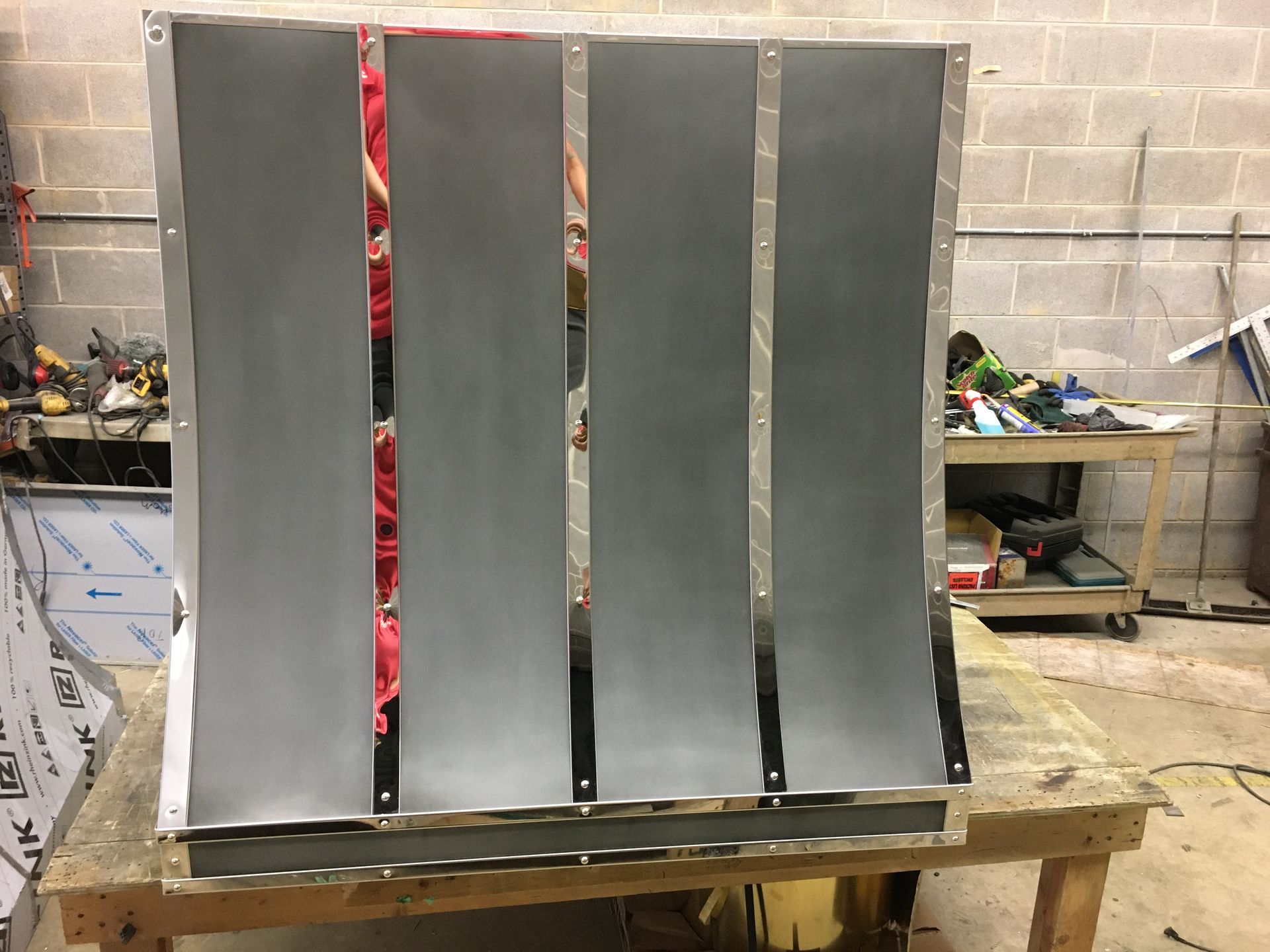 A piece of metal is sitting on top of a wooden table.