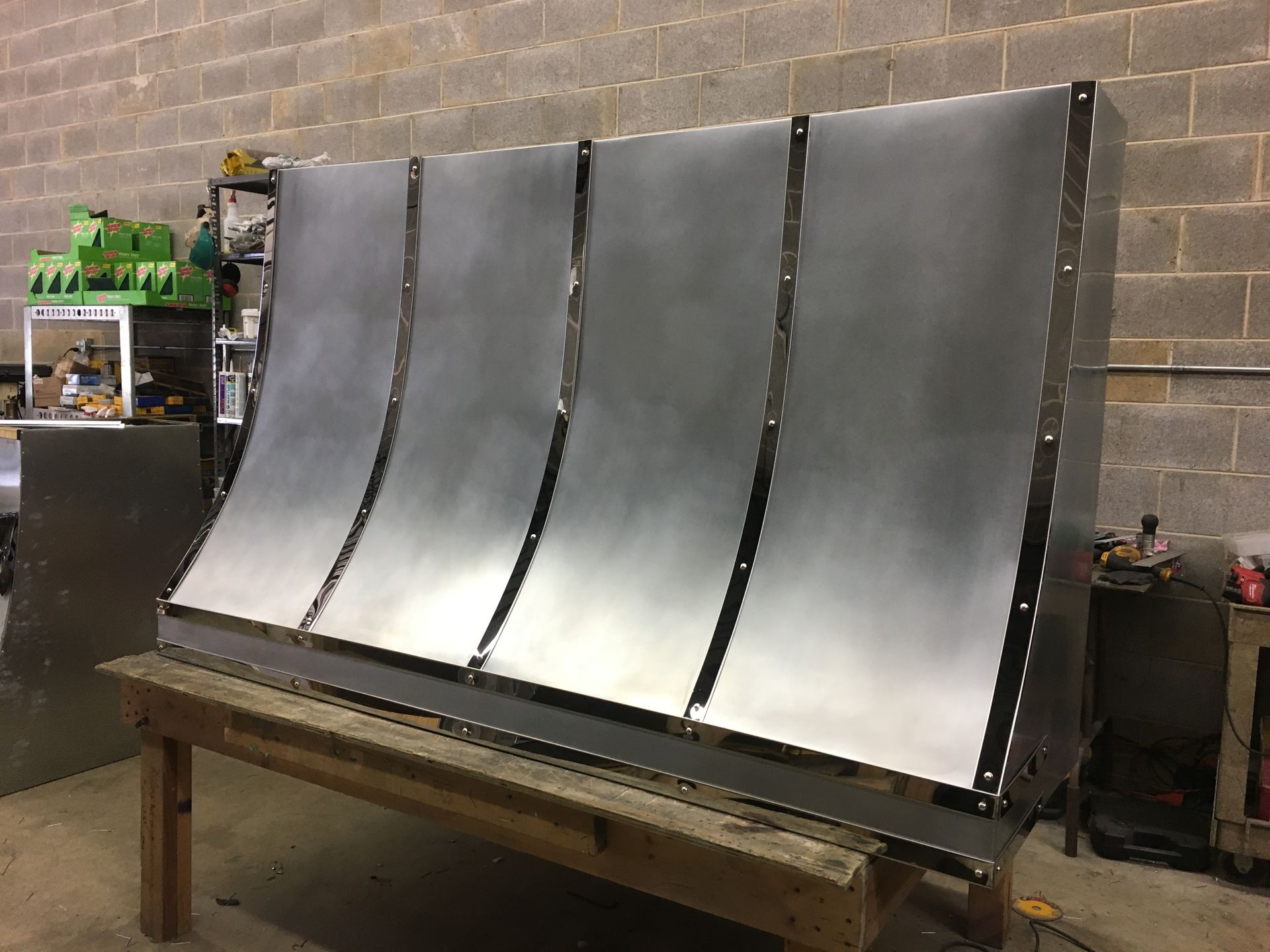 A large piece of metal is sitting on top of a wooden table.