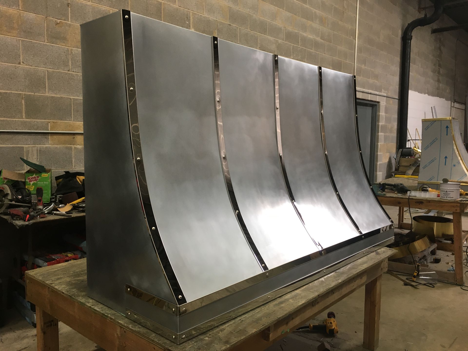 A large piece of metal is sitting on top of a wooden table.