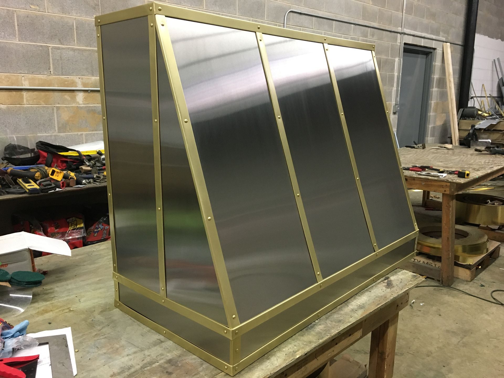 A stainless steel box is sitting on top of a wooden table.