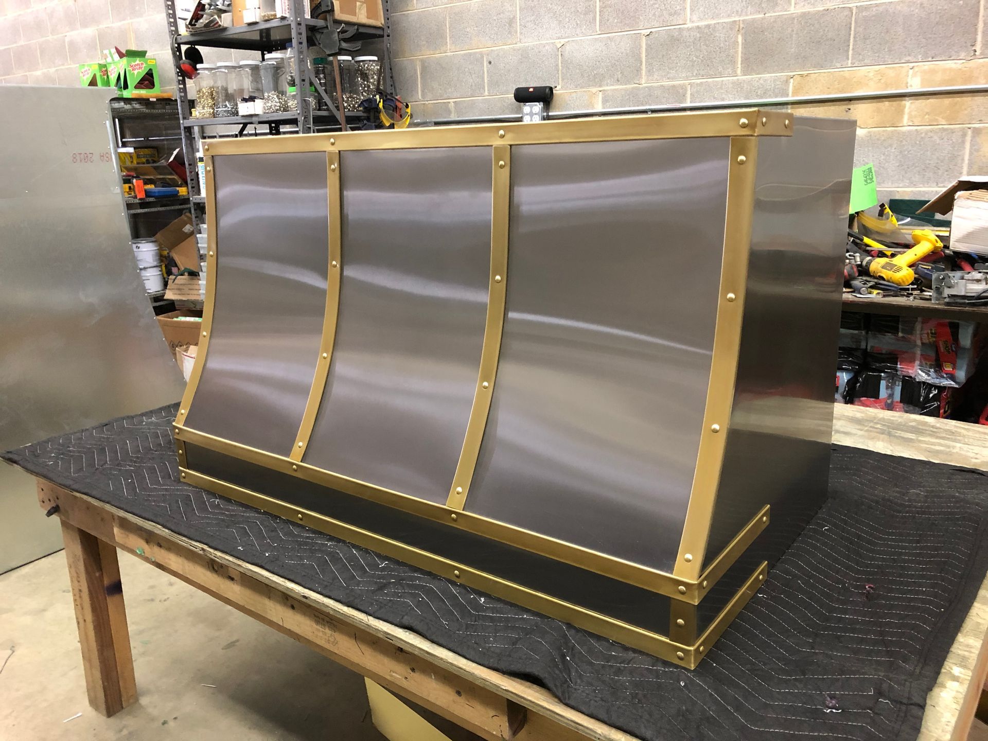 A stainless steel box is sitting on top of a wooden table.