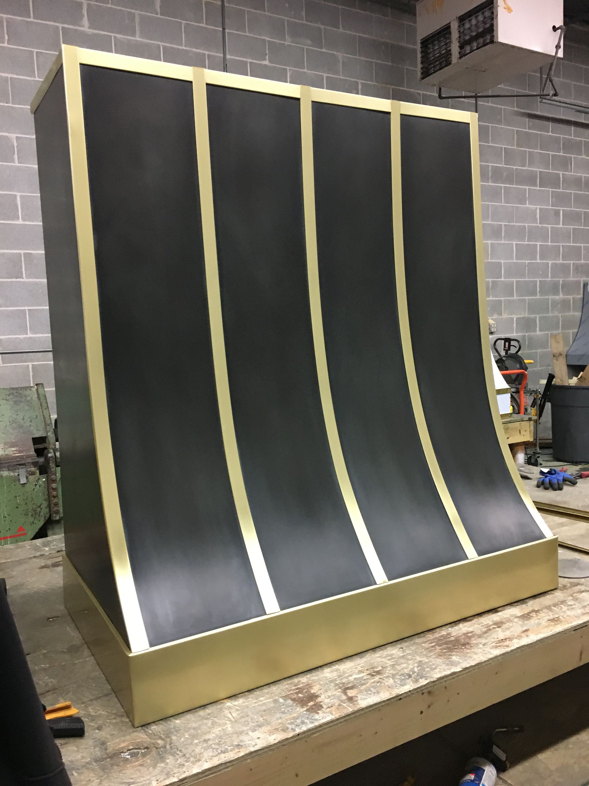 A black and gold object is sitting on a wooden table.