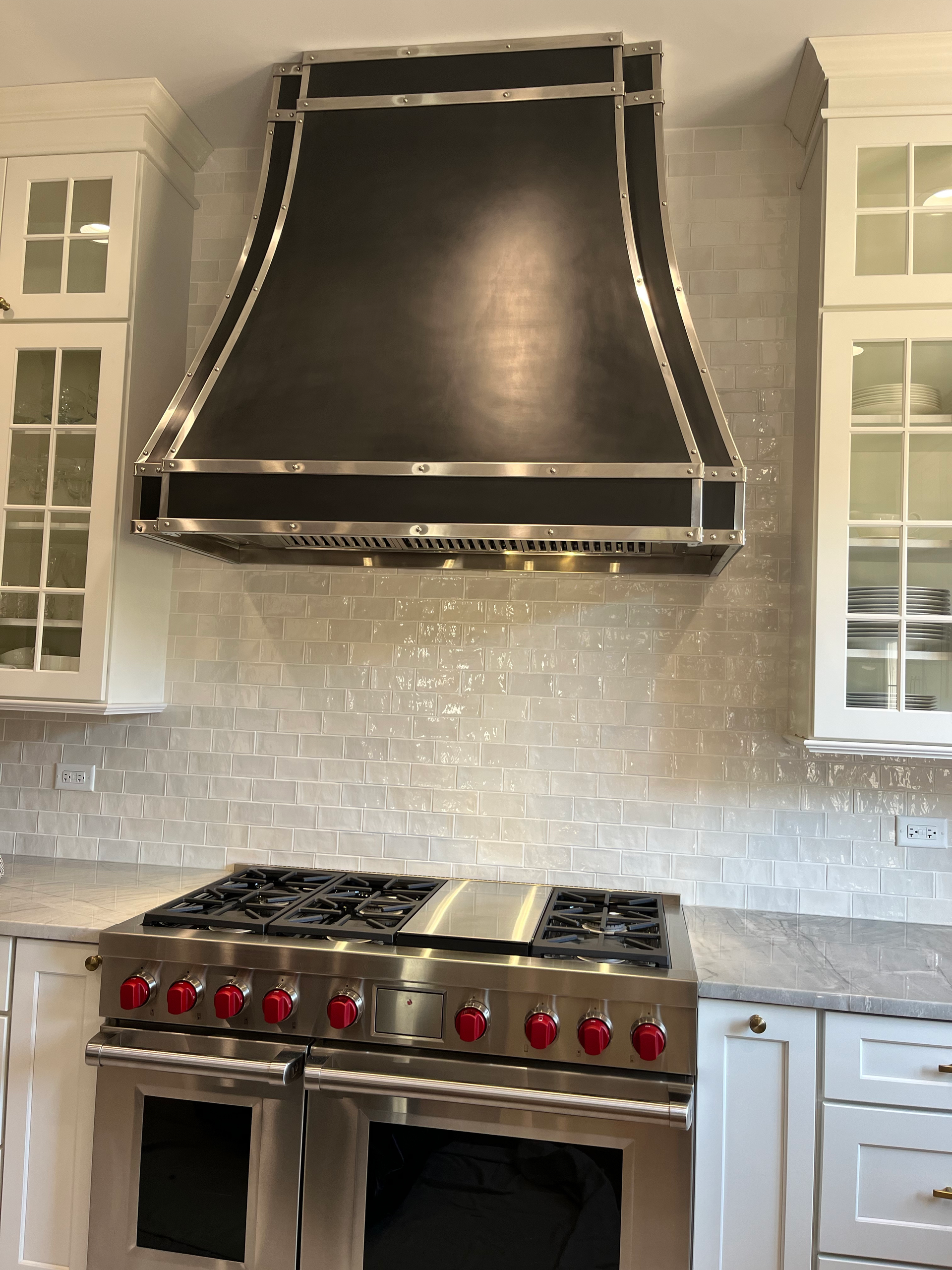 A stove with a black hood above it in a kitchen