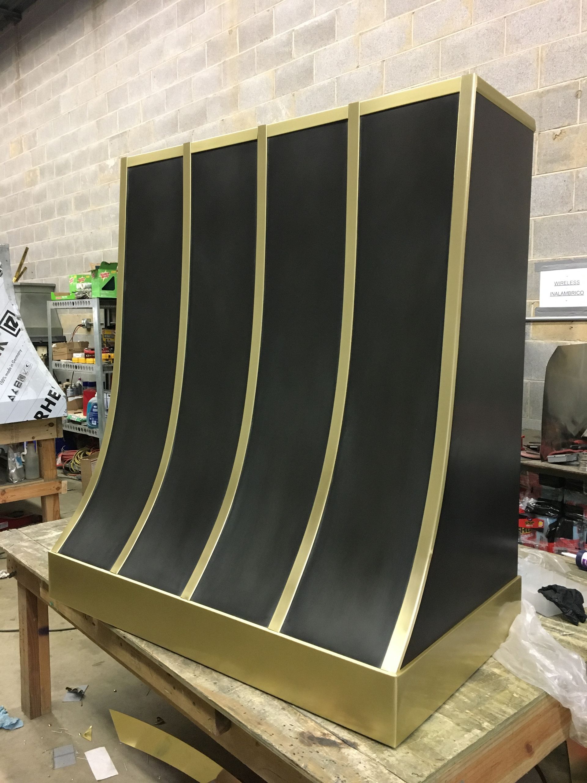 A black and gold item is sitting on a wooden table.