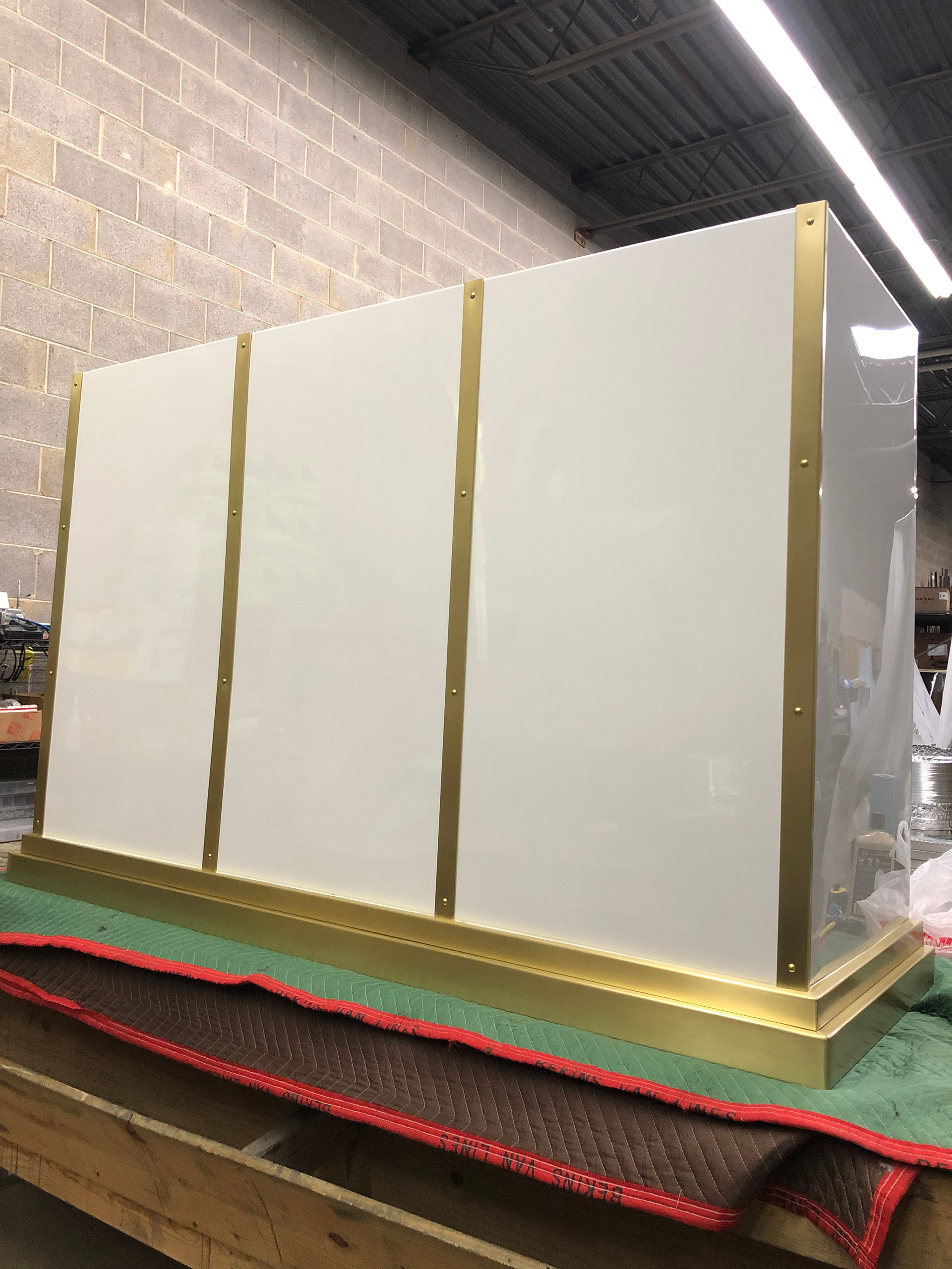 A white box with gold trim is sitting on top of a wooden table.
