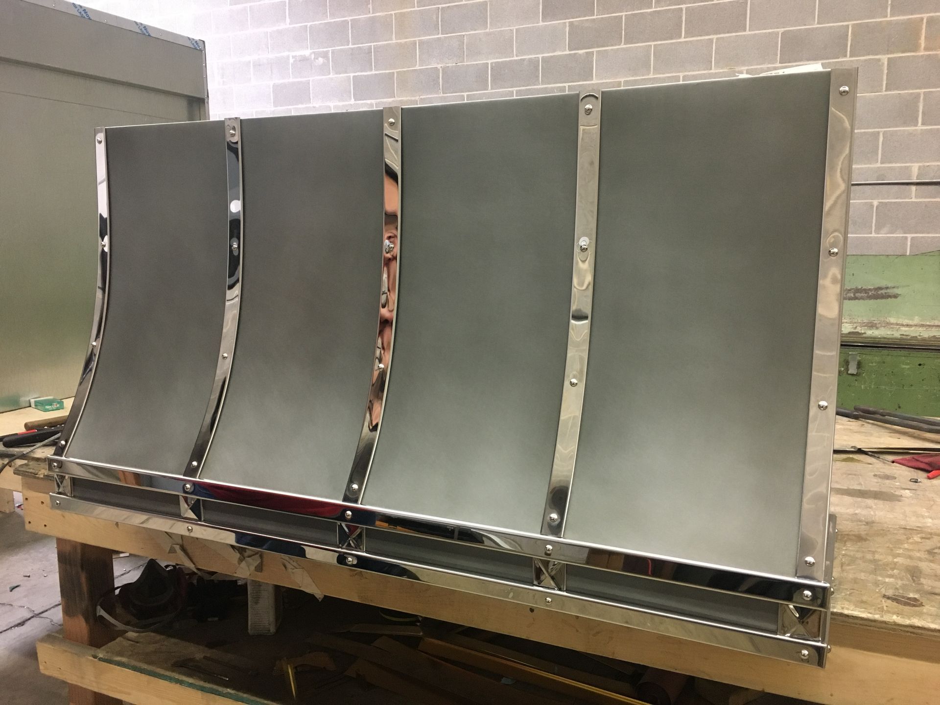 A piece of metal is sitting on top of a wooden table.