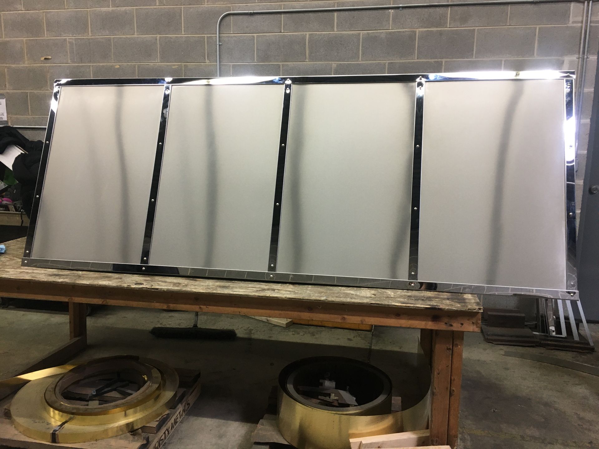 A large piece of metal is sitting on top of a wooden table.