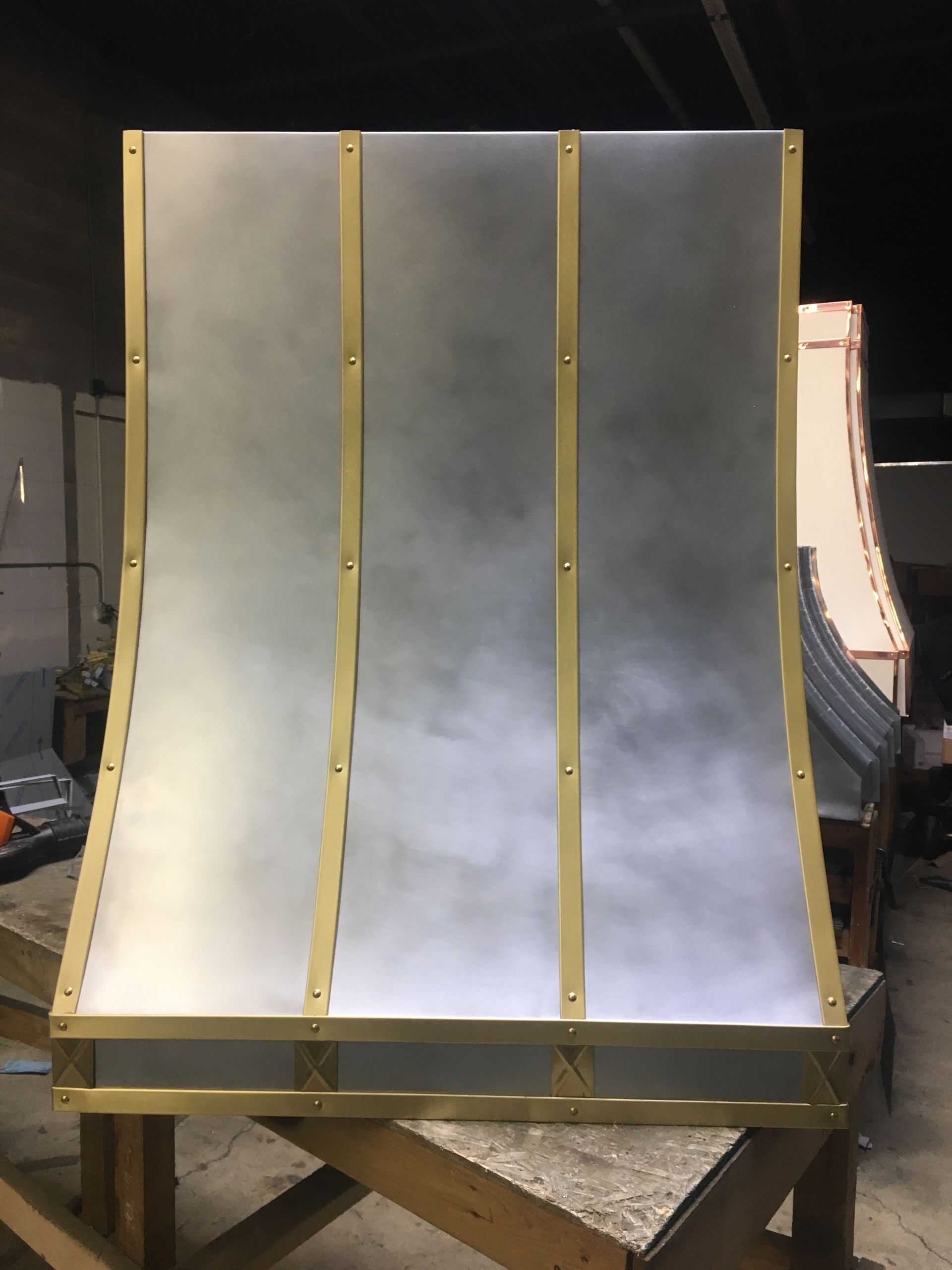 A large piece of metal is sitting on top of a wooden table.