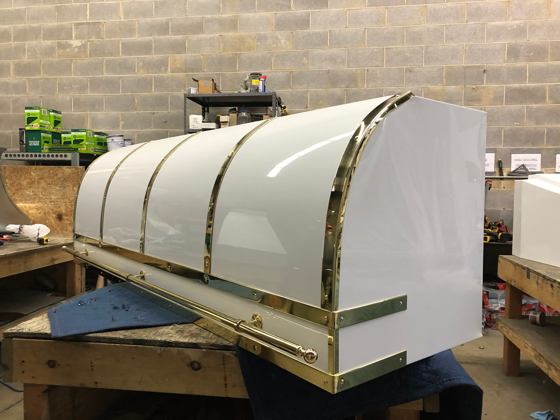 A white box with gold trim is sitting on a wooden table.