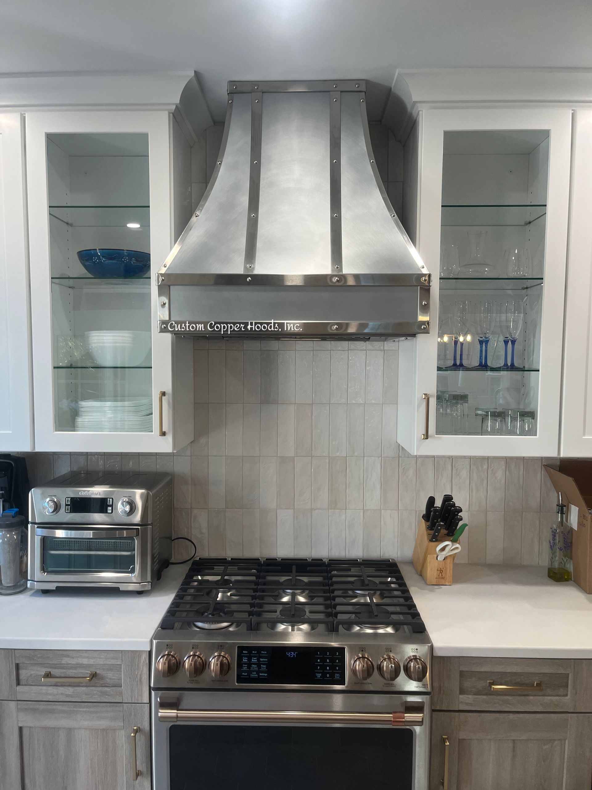 A kitchen with a stove , oven and toaster oven.