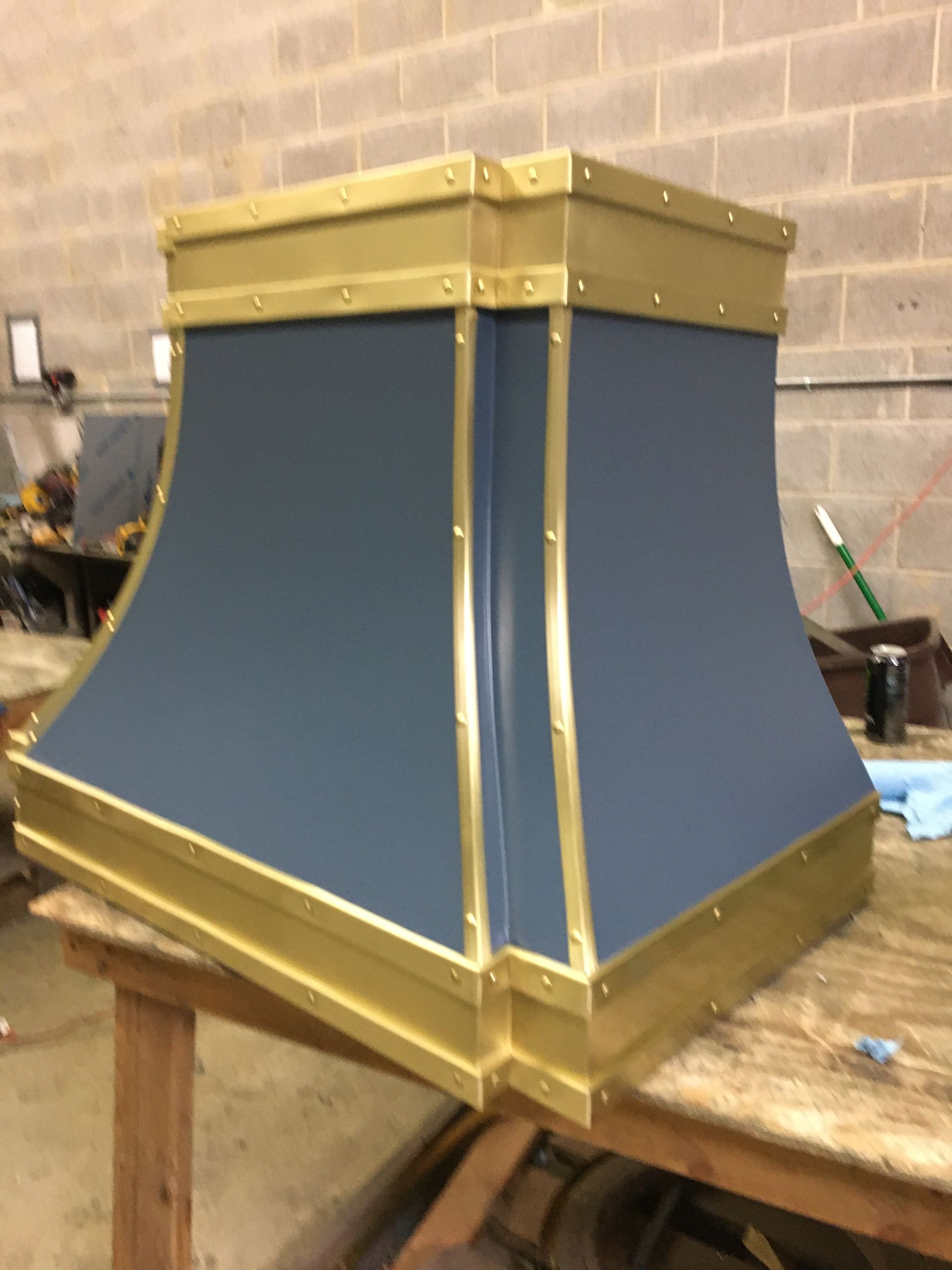 A blue and gold item is sitting on a wooden table