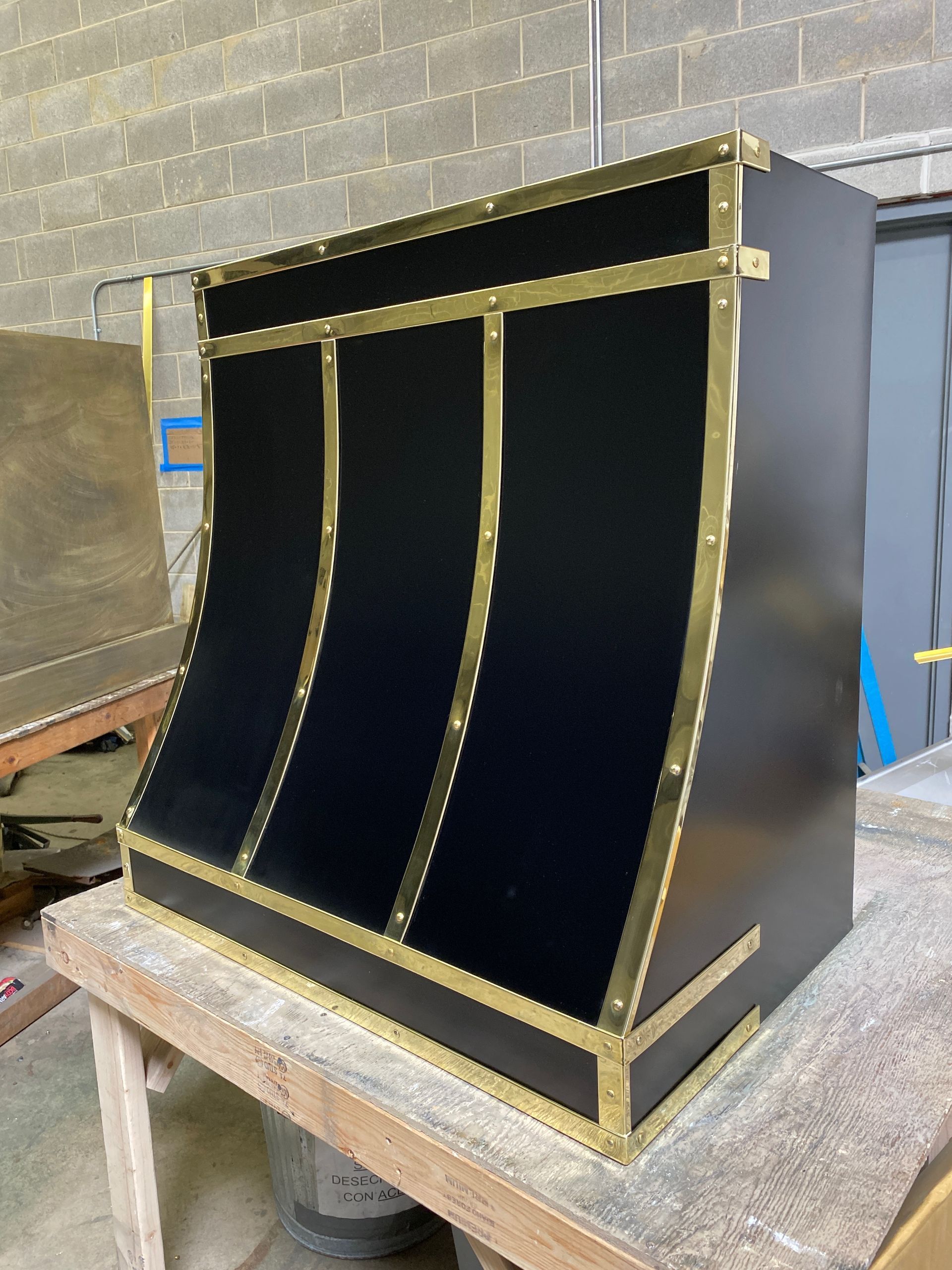 A black box with gold trim sits on a wooden table