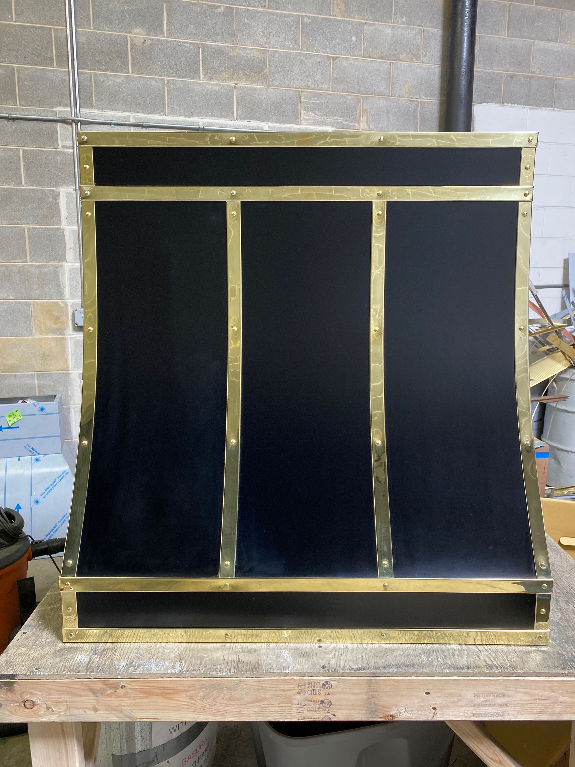 A black and gold item is sitting on a wooden table.