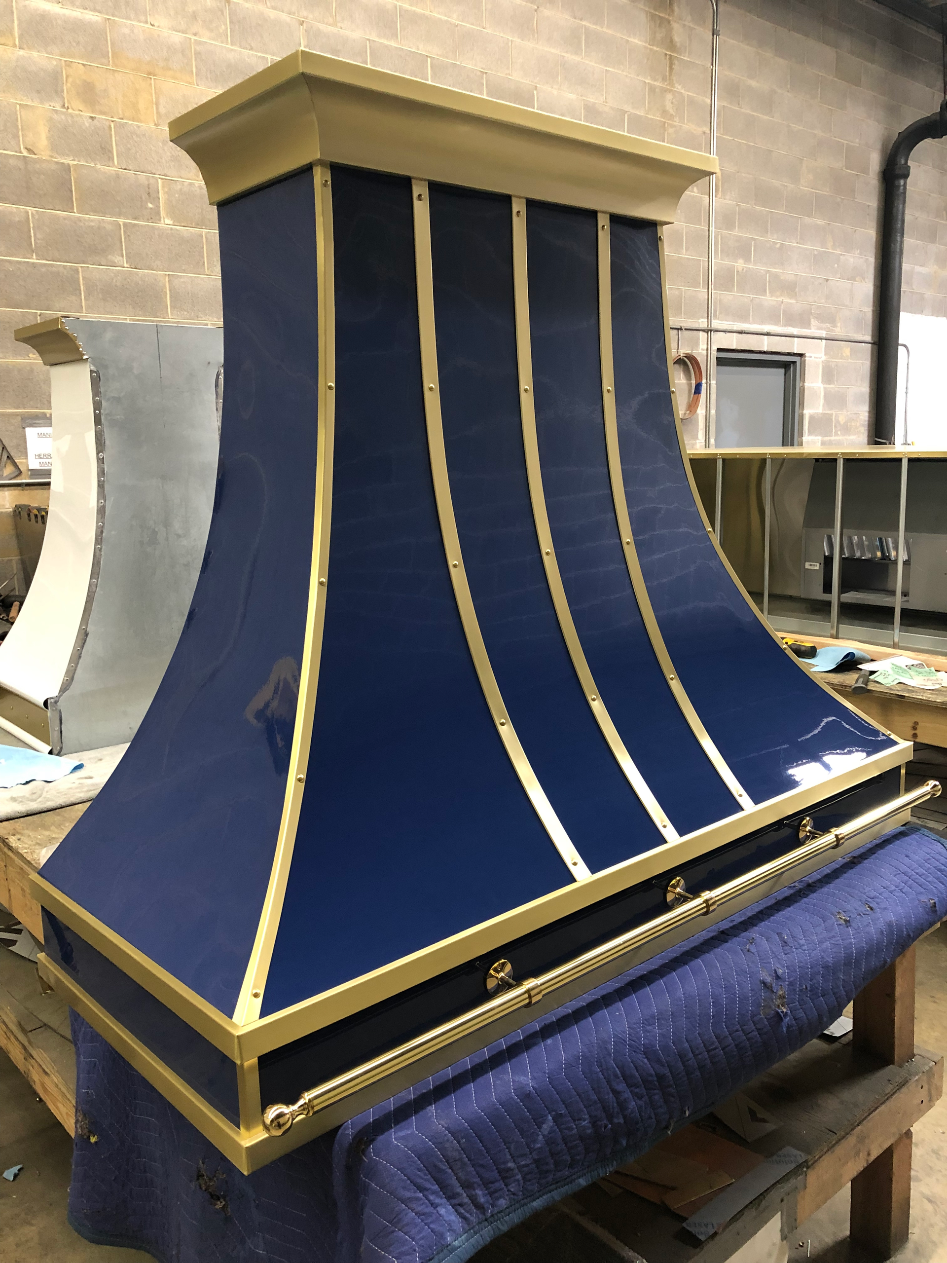 A blue and gold hood is sitting on a table