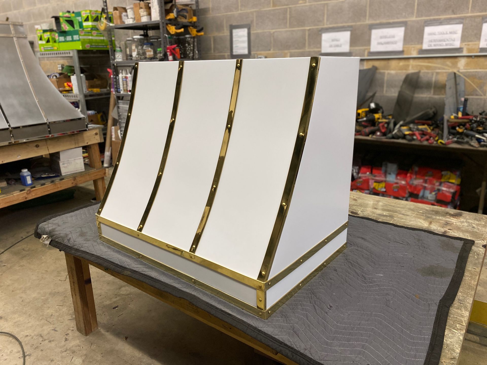 A white box with gold stripes is sitting on a table.