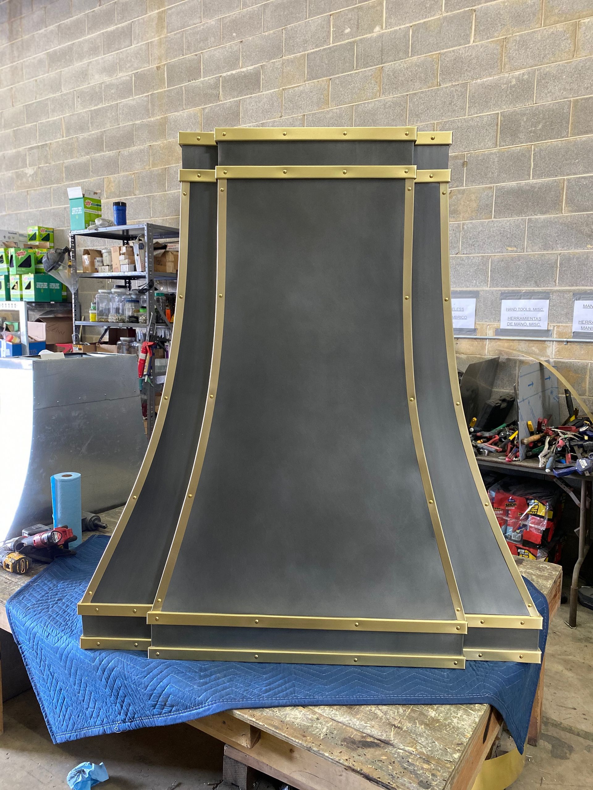 A black and gold hood is sitting on a blue blanket