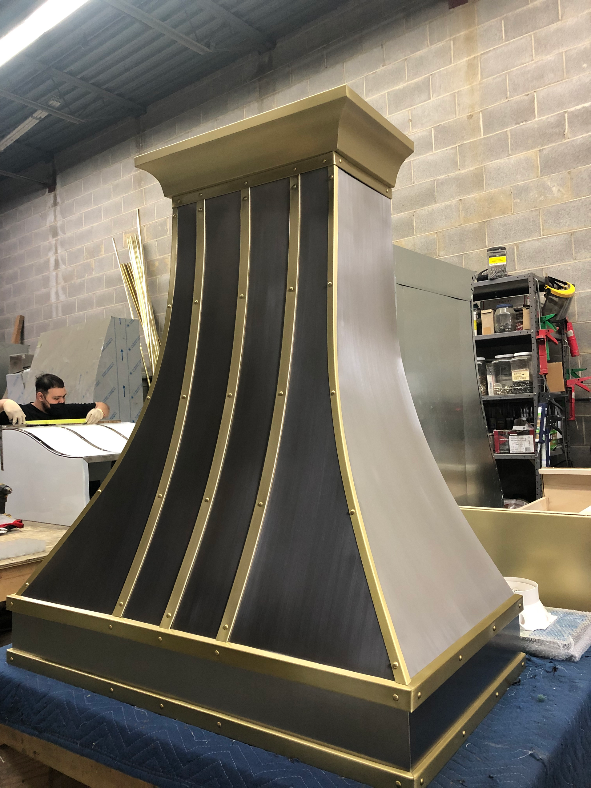 A black and gold hood is sitting on a table