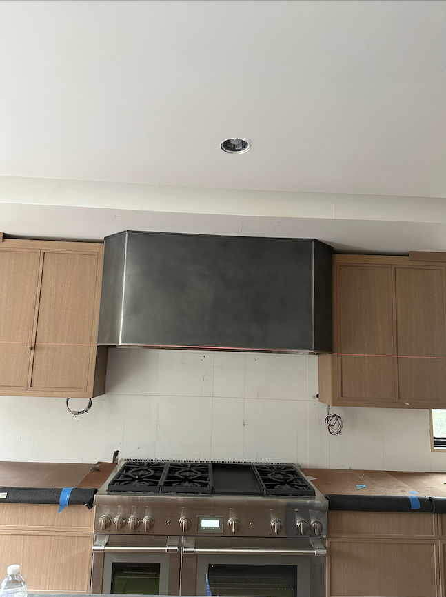 A kitchen with stainless steel appliances and wooden cabinets