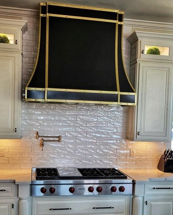 A kitchen with a black hood above the stove