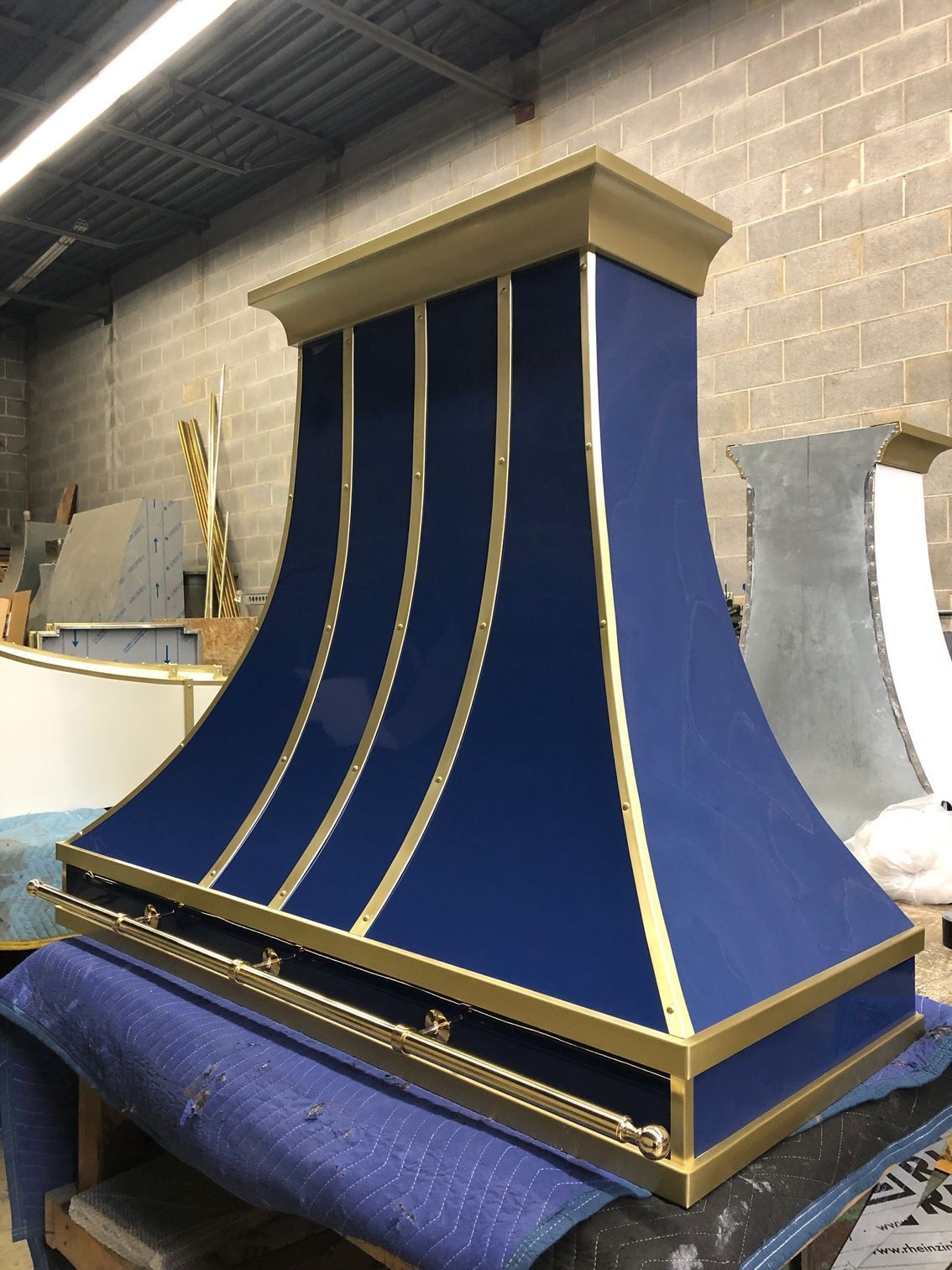 A blue and gold hood is sitting on a table
