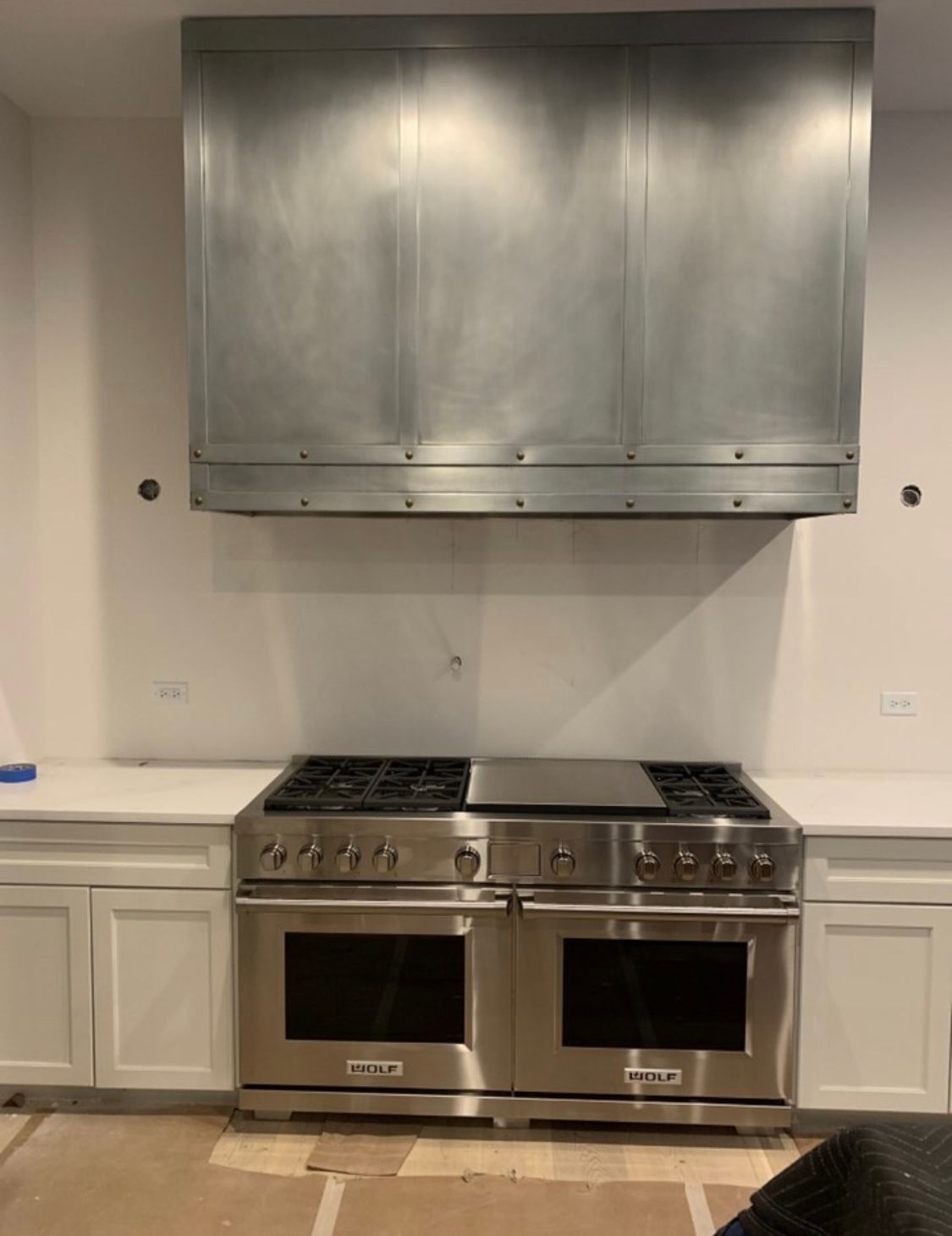 A kitchen with stainless steel appliances and white cabinets.