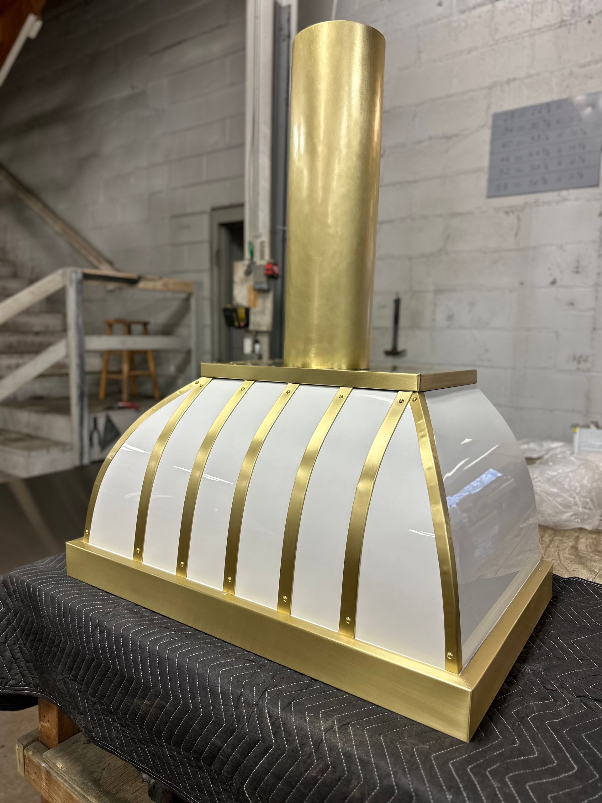 A white and gold item is sitting on a table.