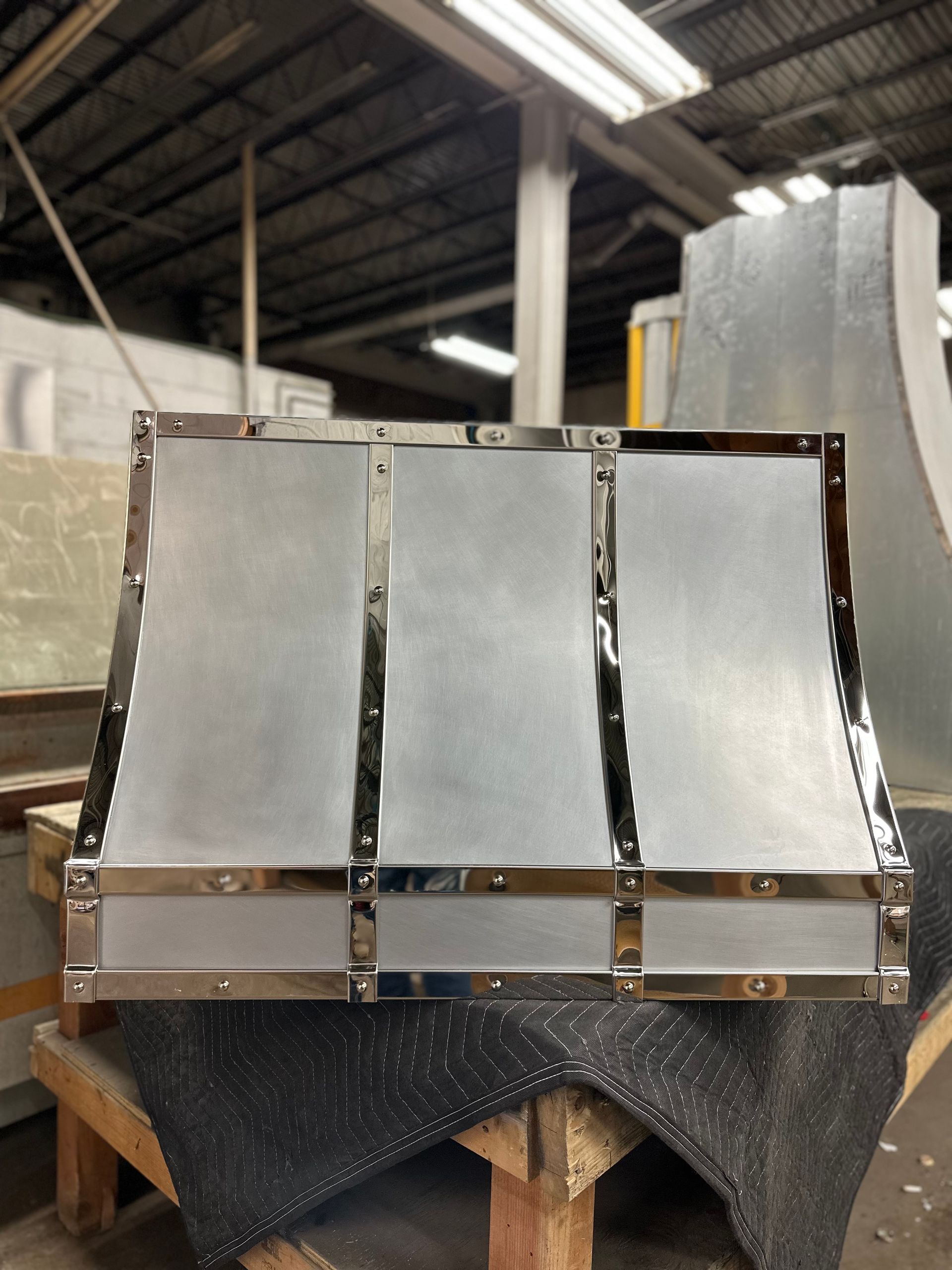 A stainless steel item is sitting on a wooden table