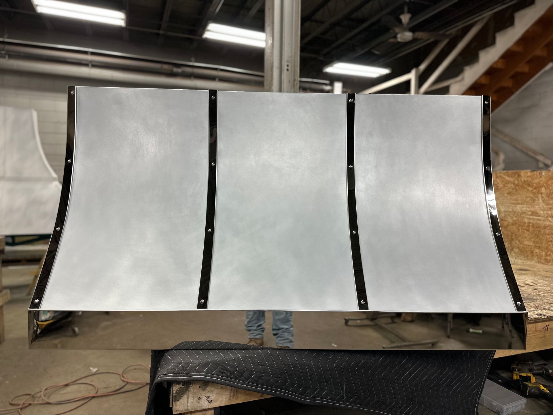 A large piece of metal is sitting on a table in a room.