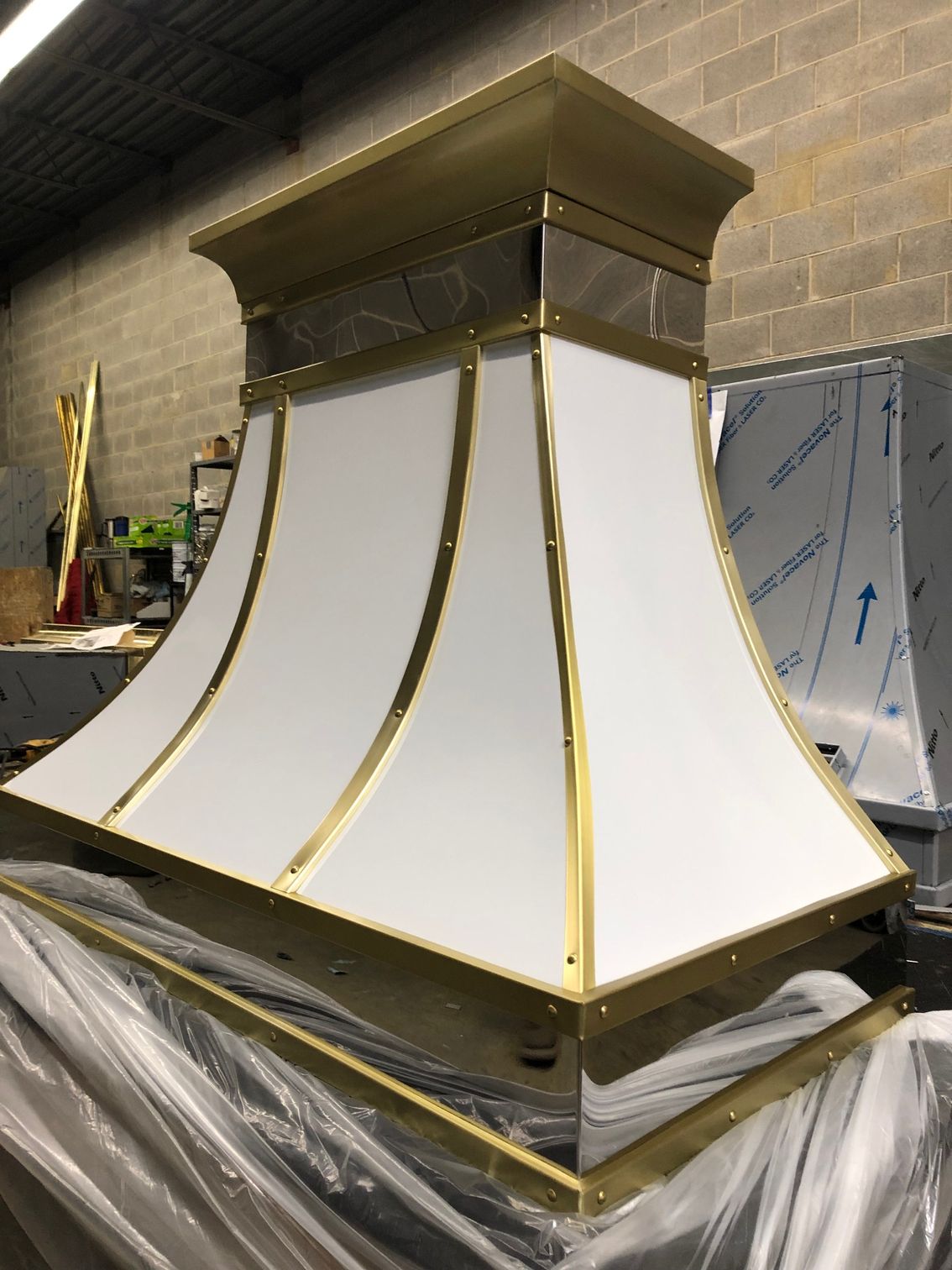 A white and gold hood is sitting on top of a table.