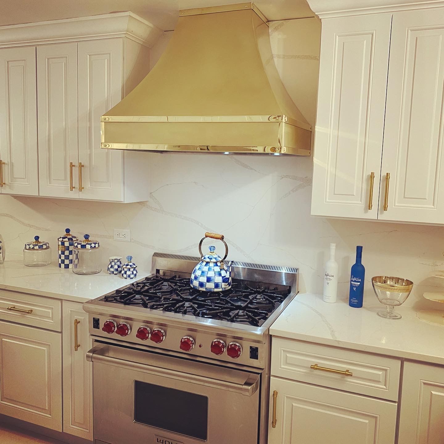 A kitchen with stainless steel appliances and white cabinets