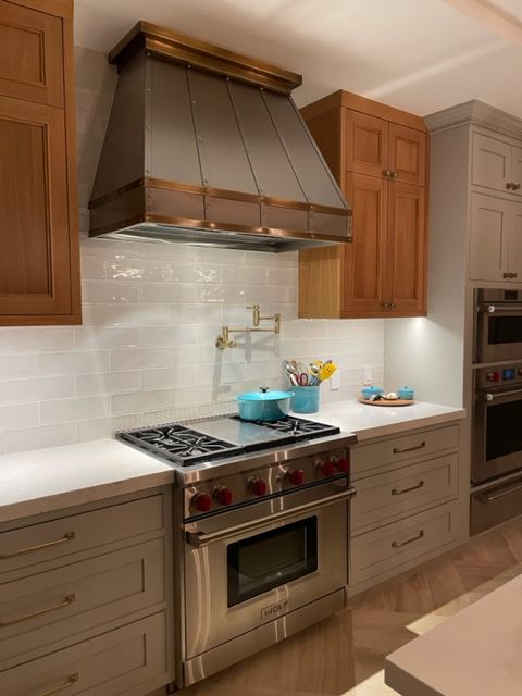 A kitchen with stainless steel appliances and wooden cabinets