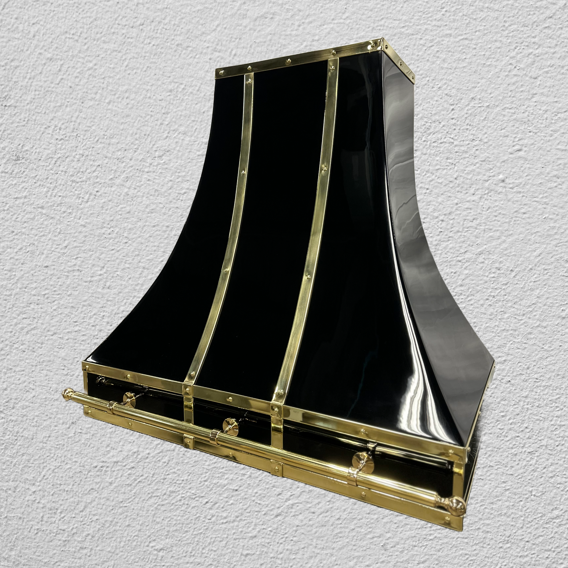 A black and gold hood is sitting on a white surface