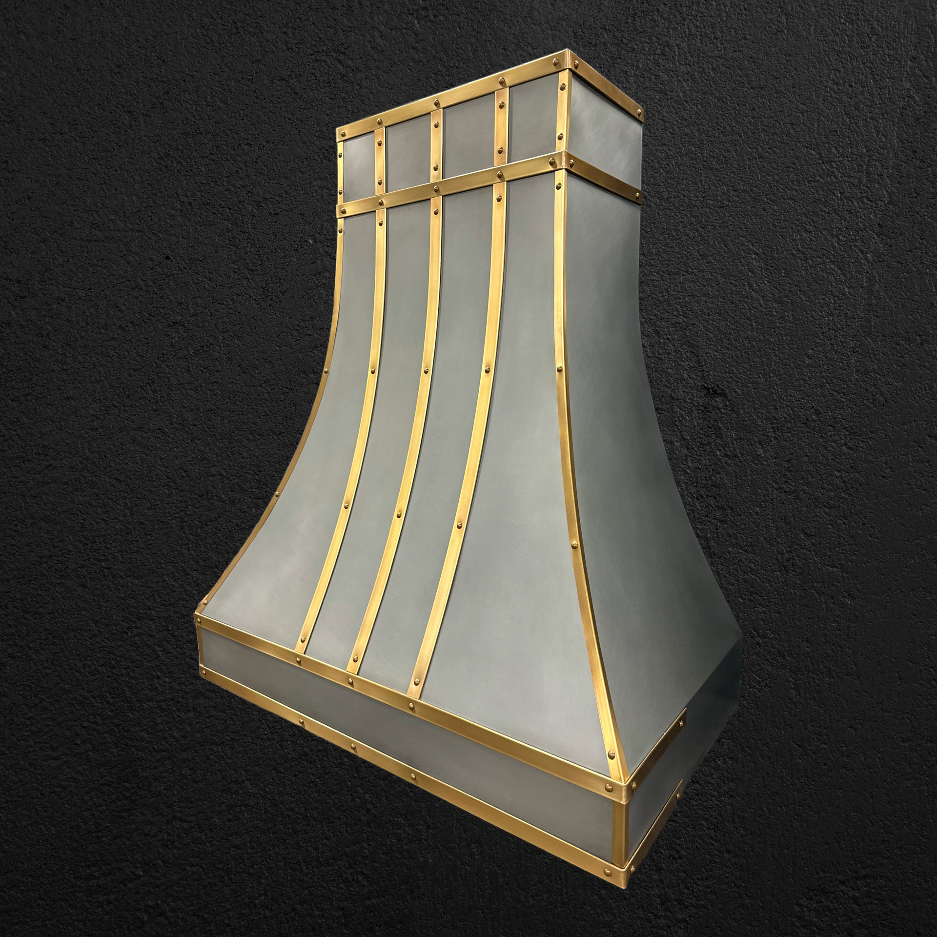 A white and gold hood is sitting on a black surface