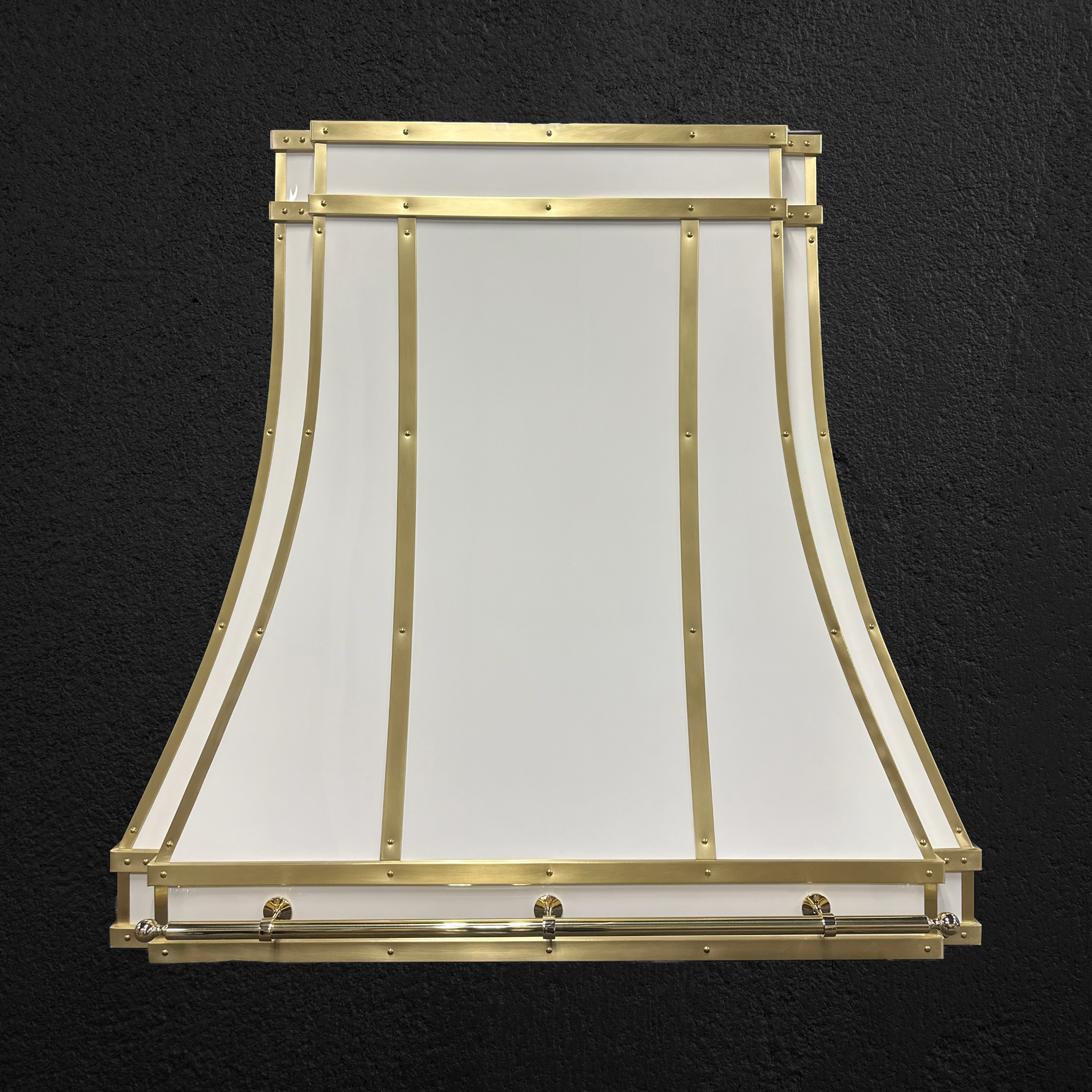 A white lampshade with gold trim on a black background