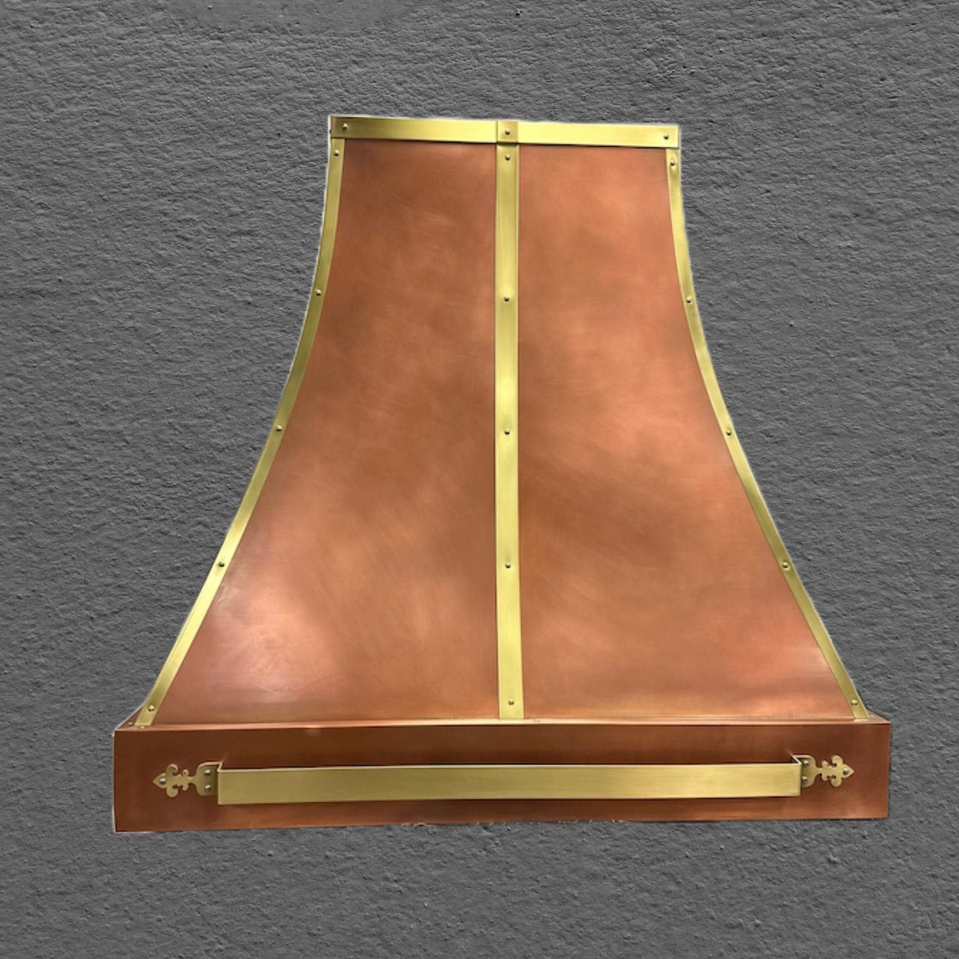 A copper hood with brass trim and handles