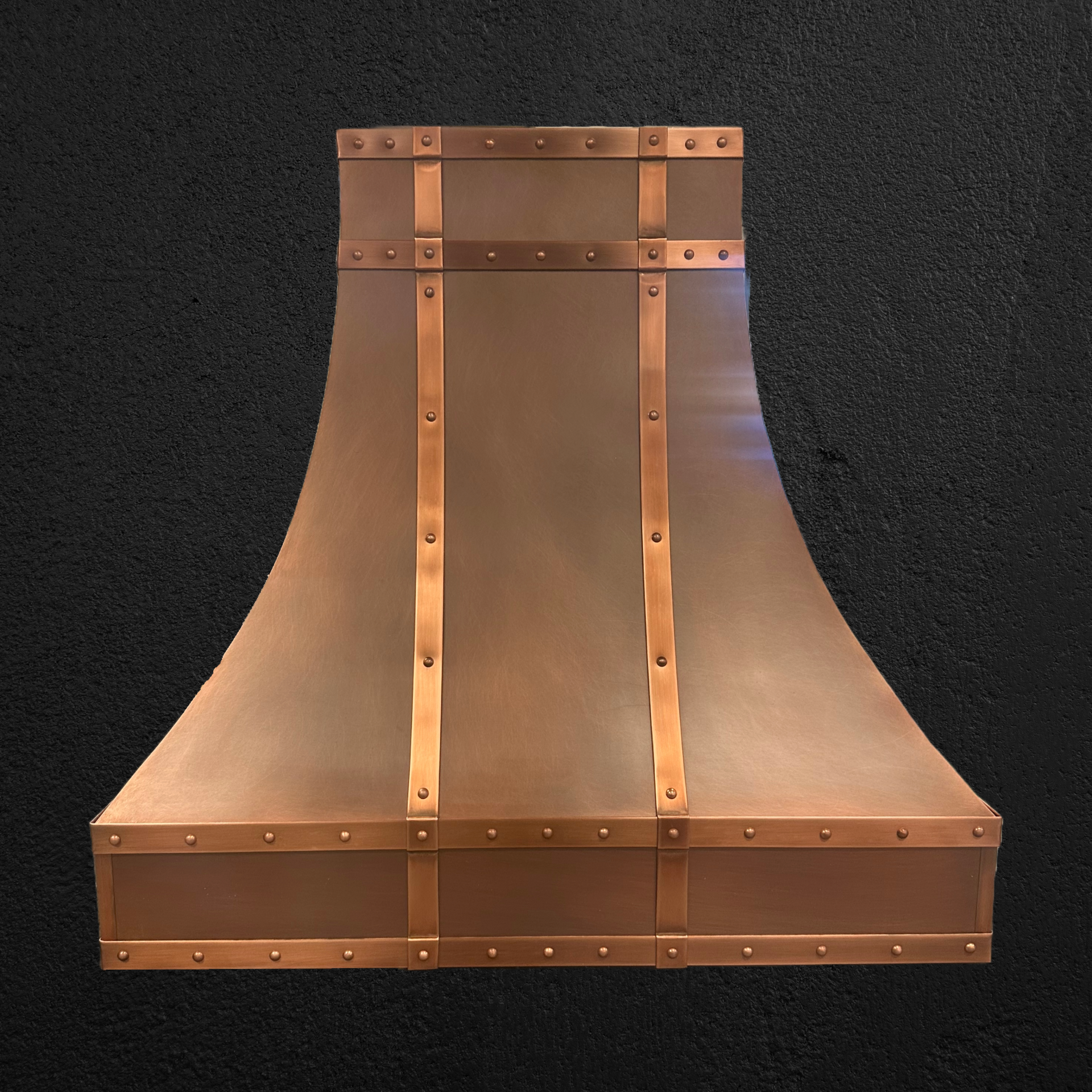 A copper hood is sitting on a black surface