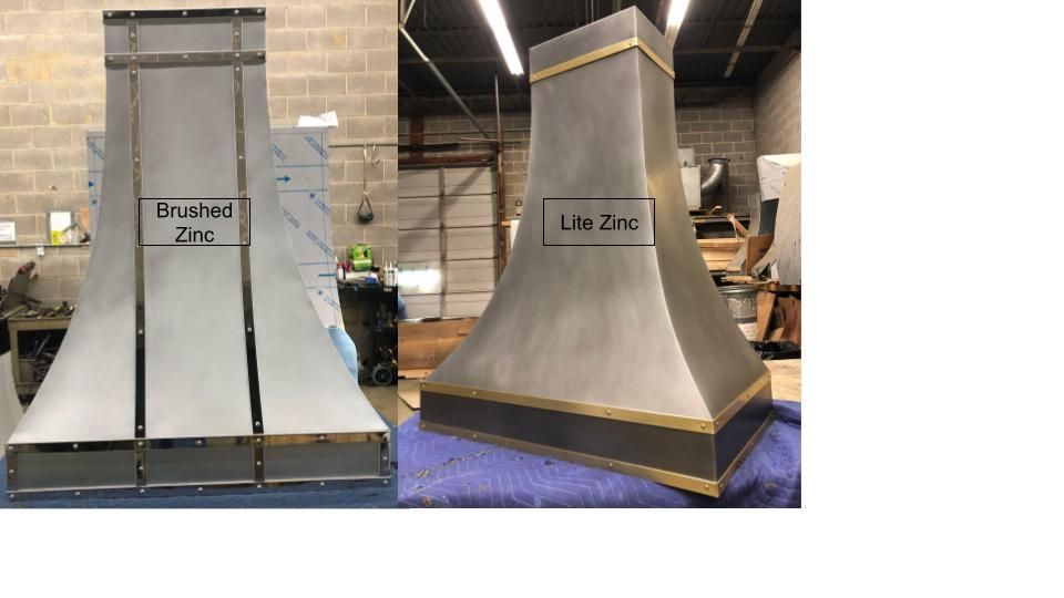 Two stainless steel hoods are sitting on a blue towel in a room.