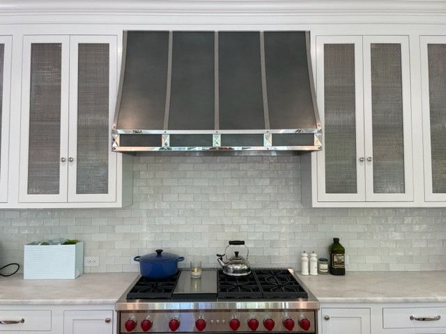 A kitchen with stainless steel appliances and white cabinets