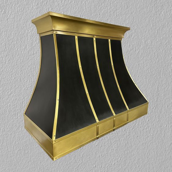 A black and gold hood is against a white wall