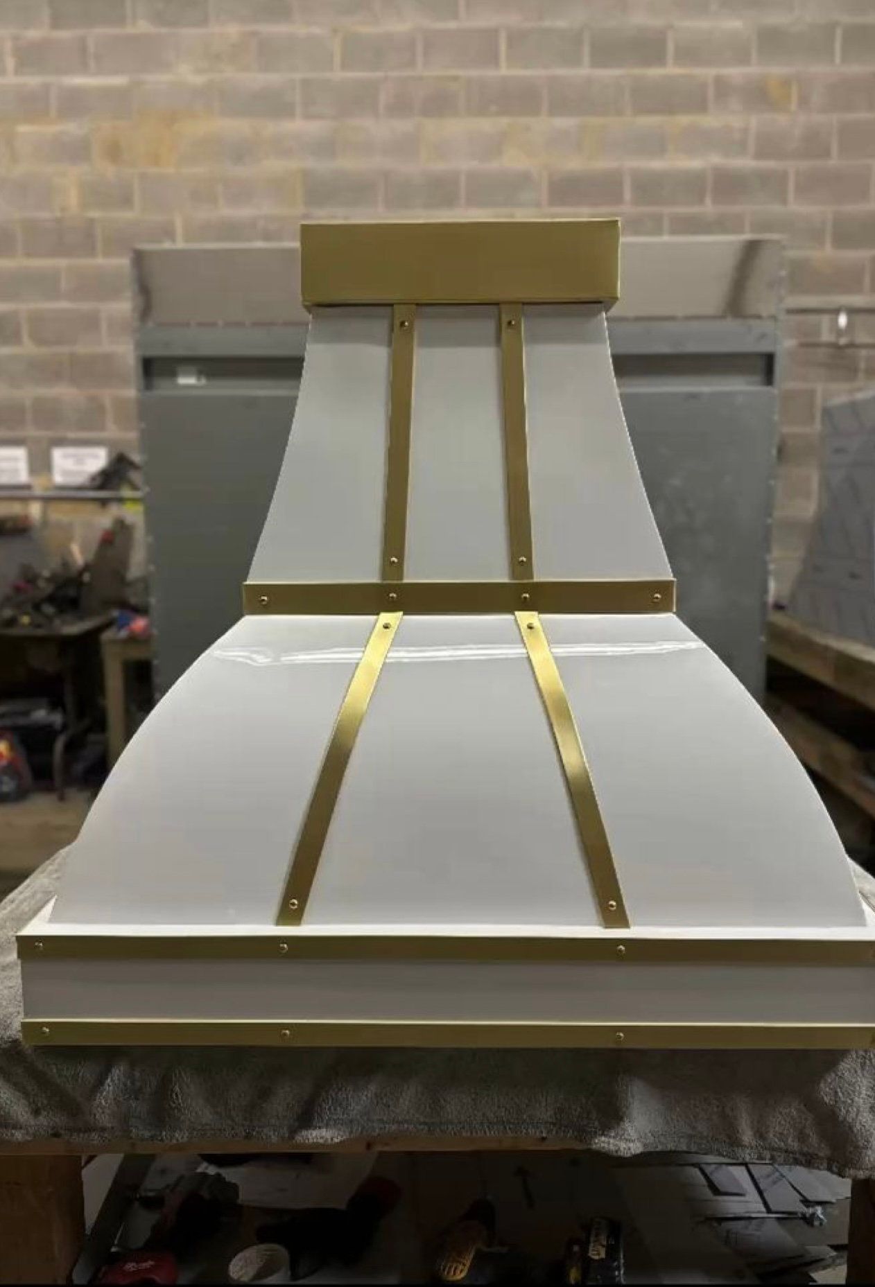 A white and gold hood is sitting on top of a table.