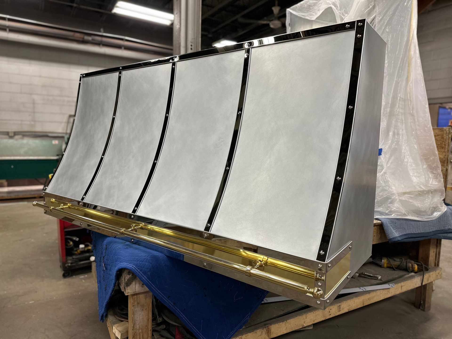 A large metal object is sitting on top of a wooden table.