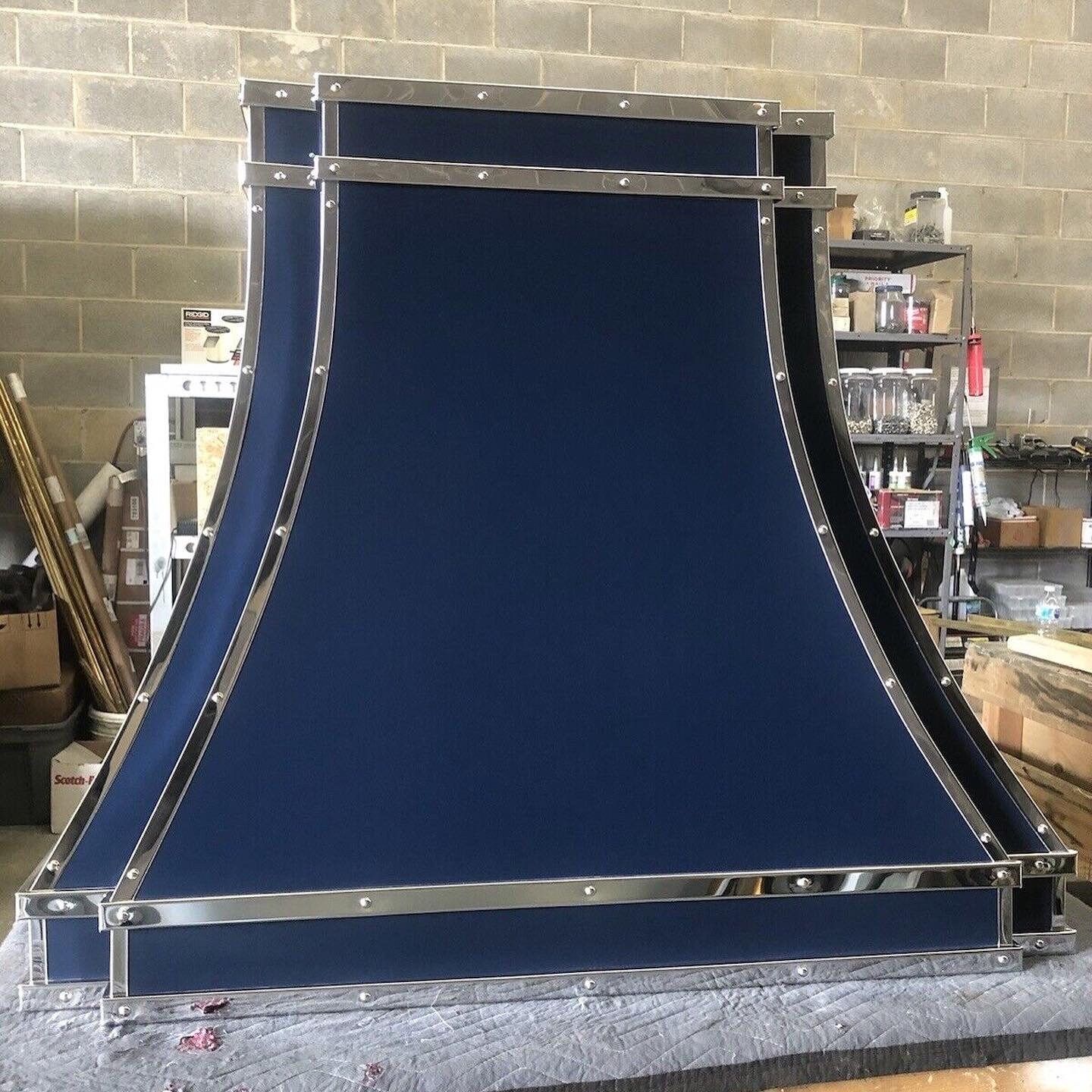 A blue hood with a stainless steel frame