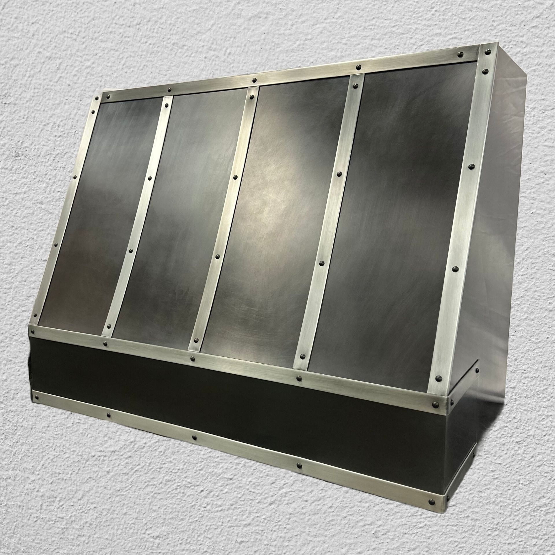 A stainless steel box is sitting on a white surface.